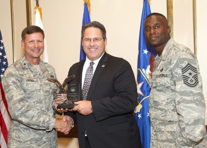 Mark Tharp receives the Civilian Supervisor of the Quarter Category II award from Brig. Gen. Leonard Patrick, 502nd Air Base Wing commander, and Chief Master Sgt. Juan Lewis, 502nd ABW command chief, during the 502nd ABW second quarter awards luncheon July 27 at the Kelly Club. Mr. Tharp is with the 802nd Force Support Squadron. (U.S. Air Force photo/Robbin Cresswell)