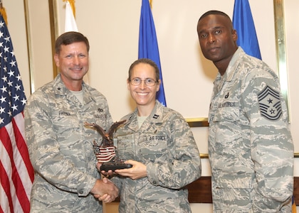 Capt. Sarah Schechter receives the Company Grade Officer of the Quarter award from Brig. Gen. Leonard Patrick, 502nd Air Base Wing commander, and Chief Master Sgt. Juan Lewis, 502nd ABW command chief, during the 502nd ABW second quarter awards luncheon July 27 at the Kelly Club. Captain Schechter is with the 502nd Air Base Wing Chaplain's Office. (U.S. Air Force photo/Robbin Cresswell) 