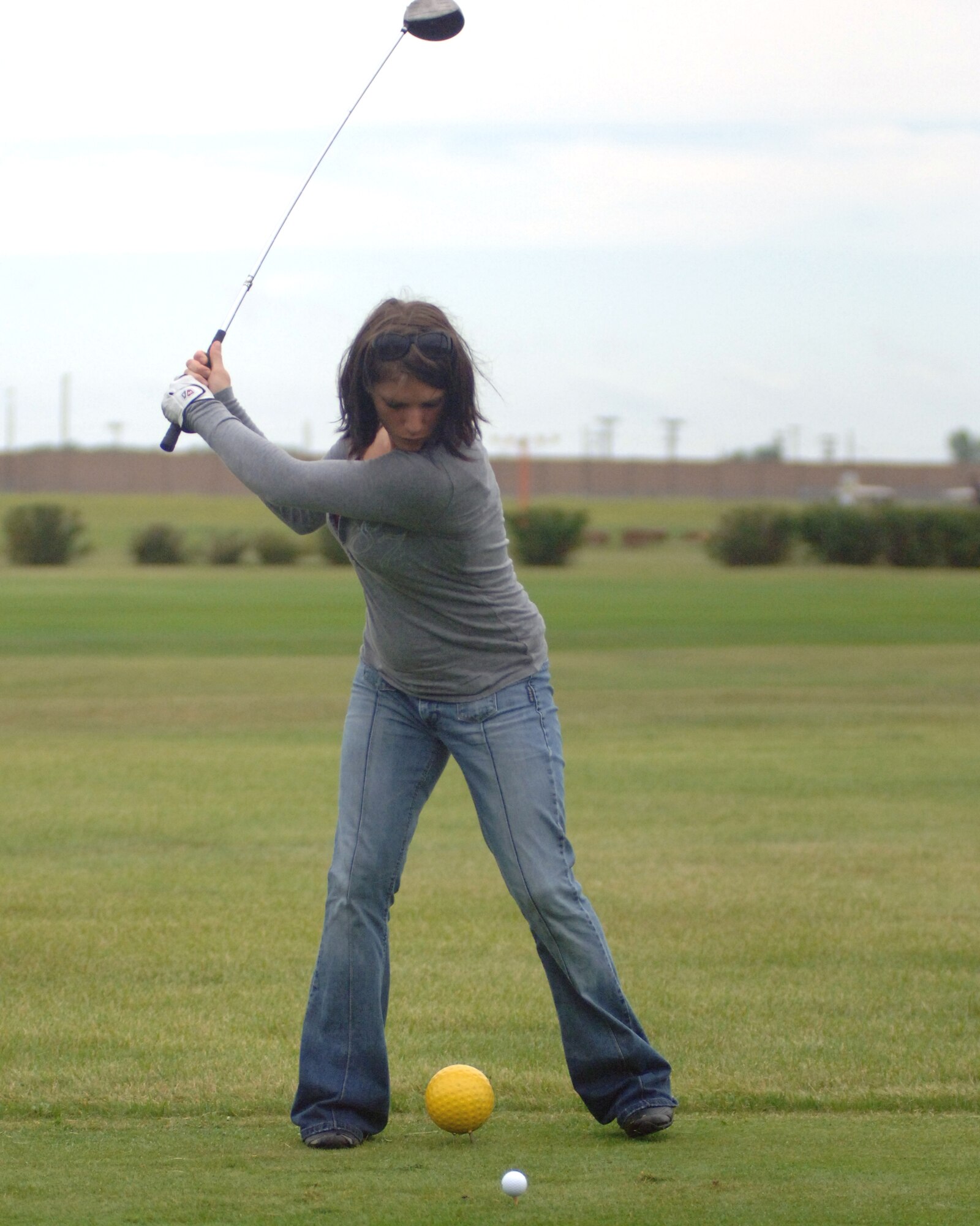 Senior Airman Whitney M. Wright, 319th Security Forces Squadron, prepares to hit a golf ball July 27 during the Airmen Against Drunk Driving Golf Tournament at the Plainsview Golf Course on Grand Forks Air Force Base, N.D. The tournament was held to raise money for AADD, which provides free, safe and confidential rides to military members, military dependents and Department of Defense civilians who need a ride after drinking. For more information on AADD, contact your unit first sergeant. (U.S. Air Force photo by Staff Sgt. R. Michael Longoria)