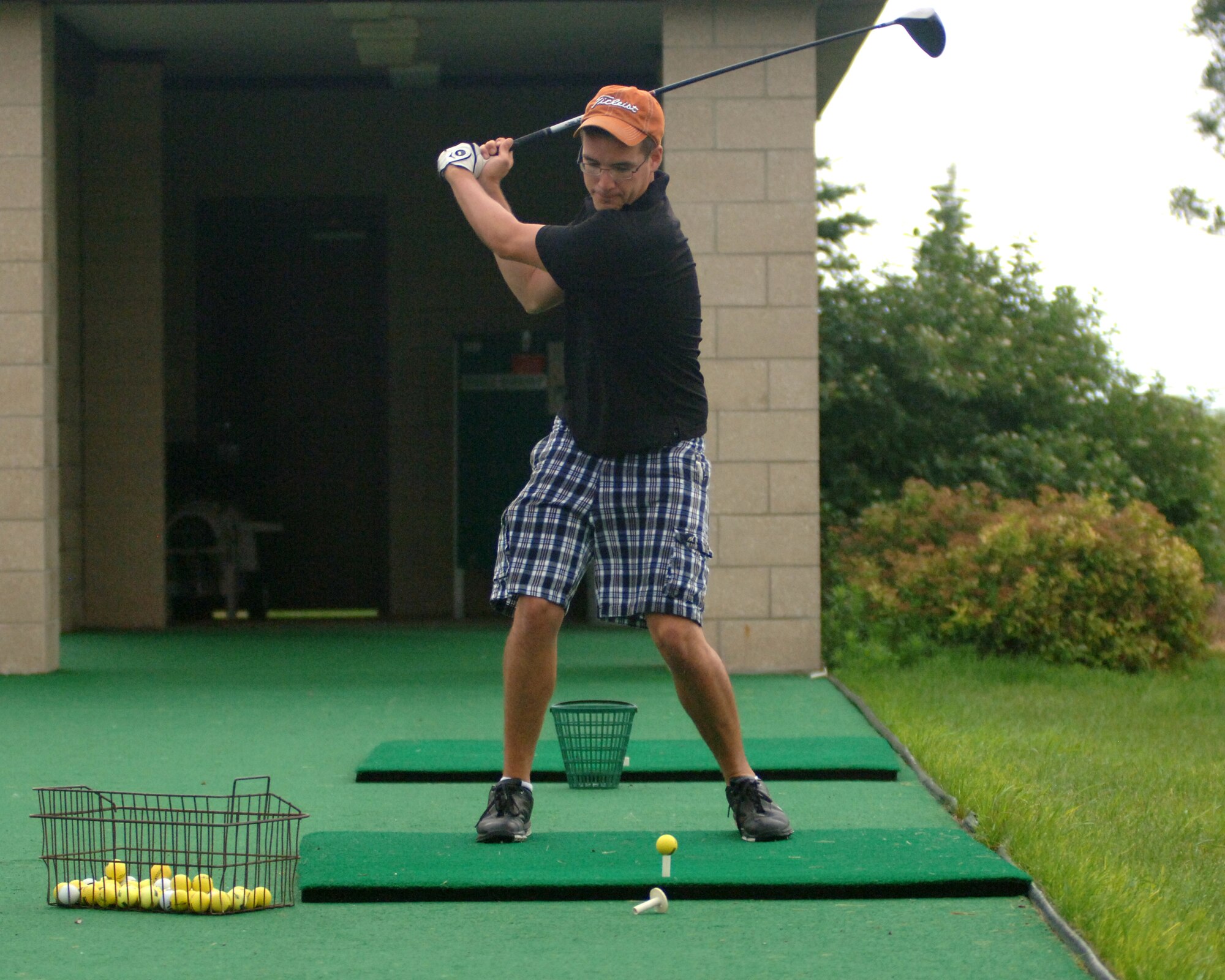 Airman 1st Class Brian A. Treftz, 319th Civil Engineer Squadron, prepares to hit a golf ball on the driving range July 27 before the start of the Airmen Against Drunk Driving Golf Tournament at the Plainsview Golf Course on Grand Forks Air Force Base, N.D. The tournament was held to raise money for AADD, which provides free, safe and confidential rides to military members, military dependents and Department of Defense civilians who need a ride after drinking. For more information on AADD, contact your unit first sergeant. (U.S. Air Force photo by Staff Sgt. R. Michael Longoria)