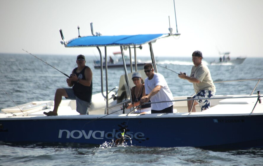 Lt. Col. Charles T. Killian catches a fish while his wife Pat watches. The Smithtown Bay Yacht Club hosted the second annual Soldiers on the Sound fishing trip on July 24, 2010 in Smithtown, N.Y. Members of the 106th Rescue Wing, from F.S. Gabreski Air National Guard Base, were the majority of participants for the event which paired the Airmen with civilians who took them on their boat to fish. The main fish the members sought to catch was the fluke. Out of the 18 boats which were deployed for the event only four regulation size fish were caught. The winning fluke was caught by SSgt. Derek Wallace, 106th Vehicle Maintenance, and it measured 4 lbs 3 ounces. 

(Official U.S. Air Force photo/SSgt David J. Murphy/released)
