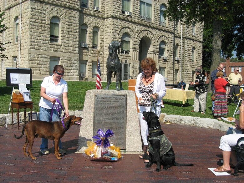 WARRENSBURG, Mo. - Citizens gather at the rededication ceremony for the Old Drum statue, originally placed at the Johnson County Courthouse in 1958.  Elvis and Bowe (along with their human guardians) enjoy their tie for first place in the Old Drum Look-alike Contest.  Warrensburg is proud of its heritage of friendship, not only because it's the home of "man's best friend" but because of the way the community welcomes the wide diversity of new neighbors. 