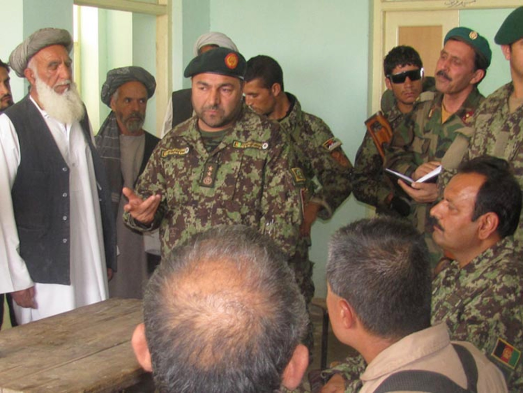 Afghan Air Force and Afghan National Army soldiers from the 209th Corps participate in their first joint Humanitarian mission distributing school supplies to children in a village outside of Mazar e Sharif, Afghanistan, on Jul. 27, 2010 (U.S. Navy photo by Mass Communications Specialist First Class Elizabeth Burke/RELEASED).