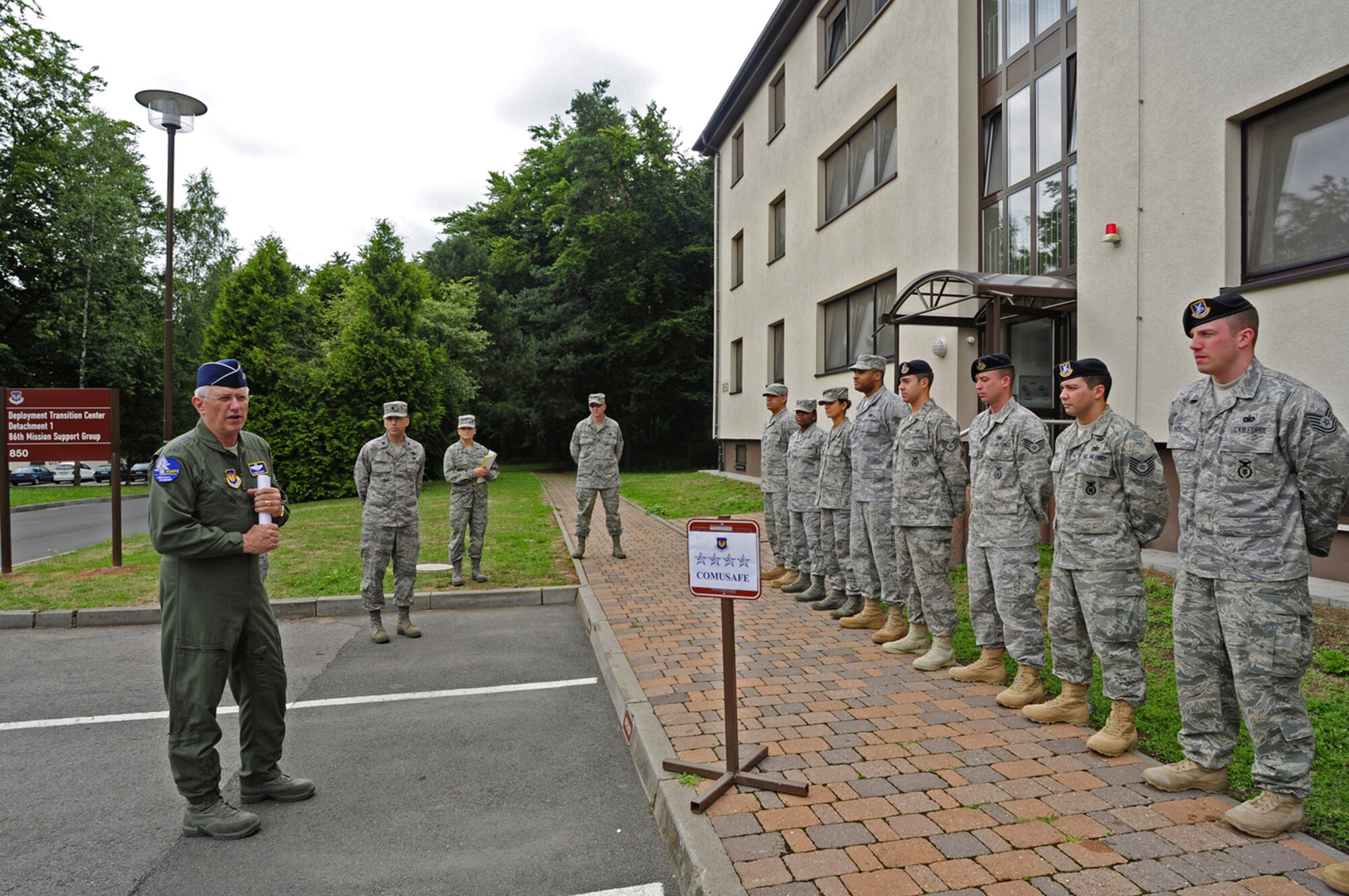 U.S. Air Force Gen. Roger A. Brady, U.S. Air Forces in Europe commander, visits the staff of the Deployment Transition Center, Detachment 1, 86th Mission Support Group, Ramstein Air Base, Germany, July 27, 2010. General Brady visited to review and discuss USAFE execution of the new Airmen Resiliency Program aimed at Airmen returning from the area of responsibility who are in career fields that experience frequent "outside-the-wire" missions. The DTC provides deployment returnees an opportunity to decompress and reintegrate into home and work life with a resilience building, strength-based approach to assisting Airmen regularly exposed to significant risk of death in a combat zone. (U.S. Air Force photo/Airman 1st Class Brea Miller)