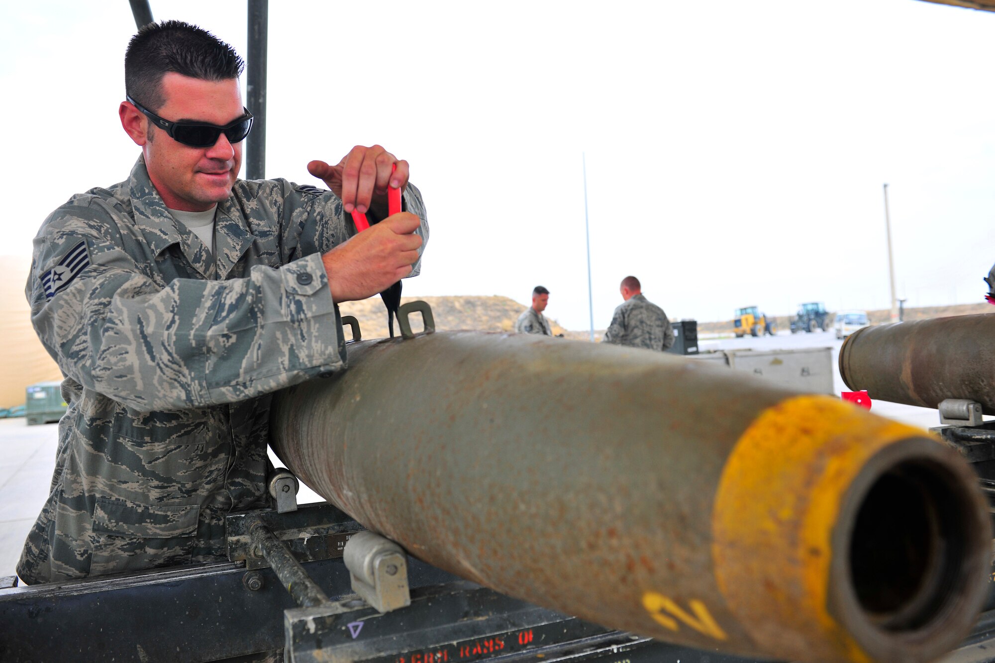 Staff Sgt. Jared Rogers, a munitions systems specialist assigned to the 455th Expeditionary Maintenance Squadron, removes a shipping plug on a bomb body where the initiator will be mounted during a bomb build at Bagram Airfield, Afghanistan, July 28, 2010. The initiator powers the fuse once it?s dropped from the aircraft. Sergeant Rogers is a native of Ocean Springs, Miss. (U.S. Air Force photo/Staff Sgt. Christopher Boitz)