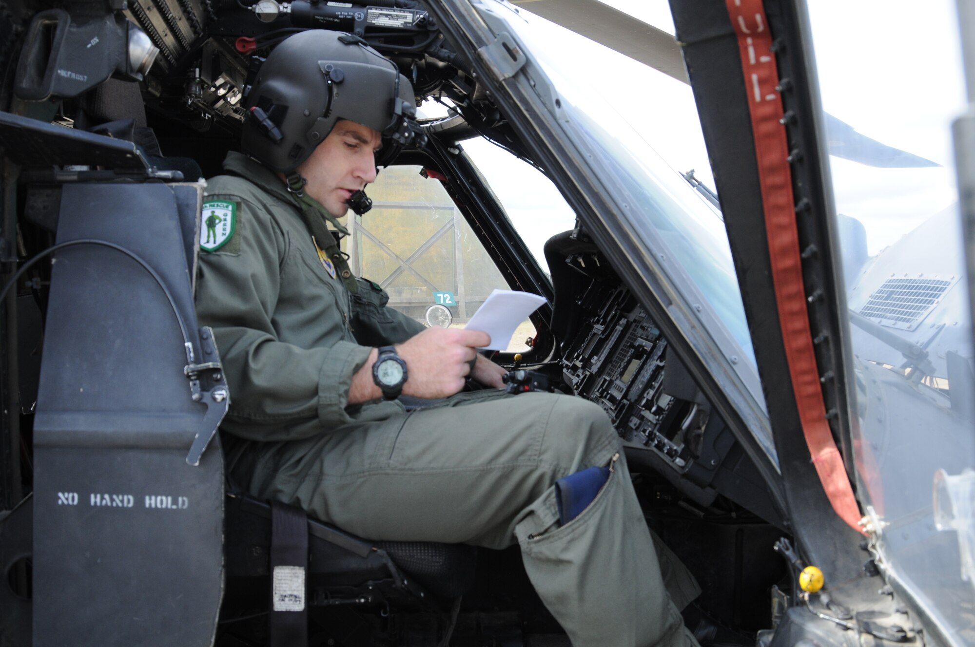 Tech. Sgt. Carl Smith, 56th Rescue Squadron flight engineer, performs a pre-flight cross check on an HH-60G helicopter July 29 at RAF Lakenheath, England. Sergeant Smith is among the 56th RQS Airmen participating in the Allied Strike exercise in Germany. (U.S. Air Force photo/Senior Airman David Dobrydney)