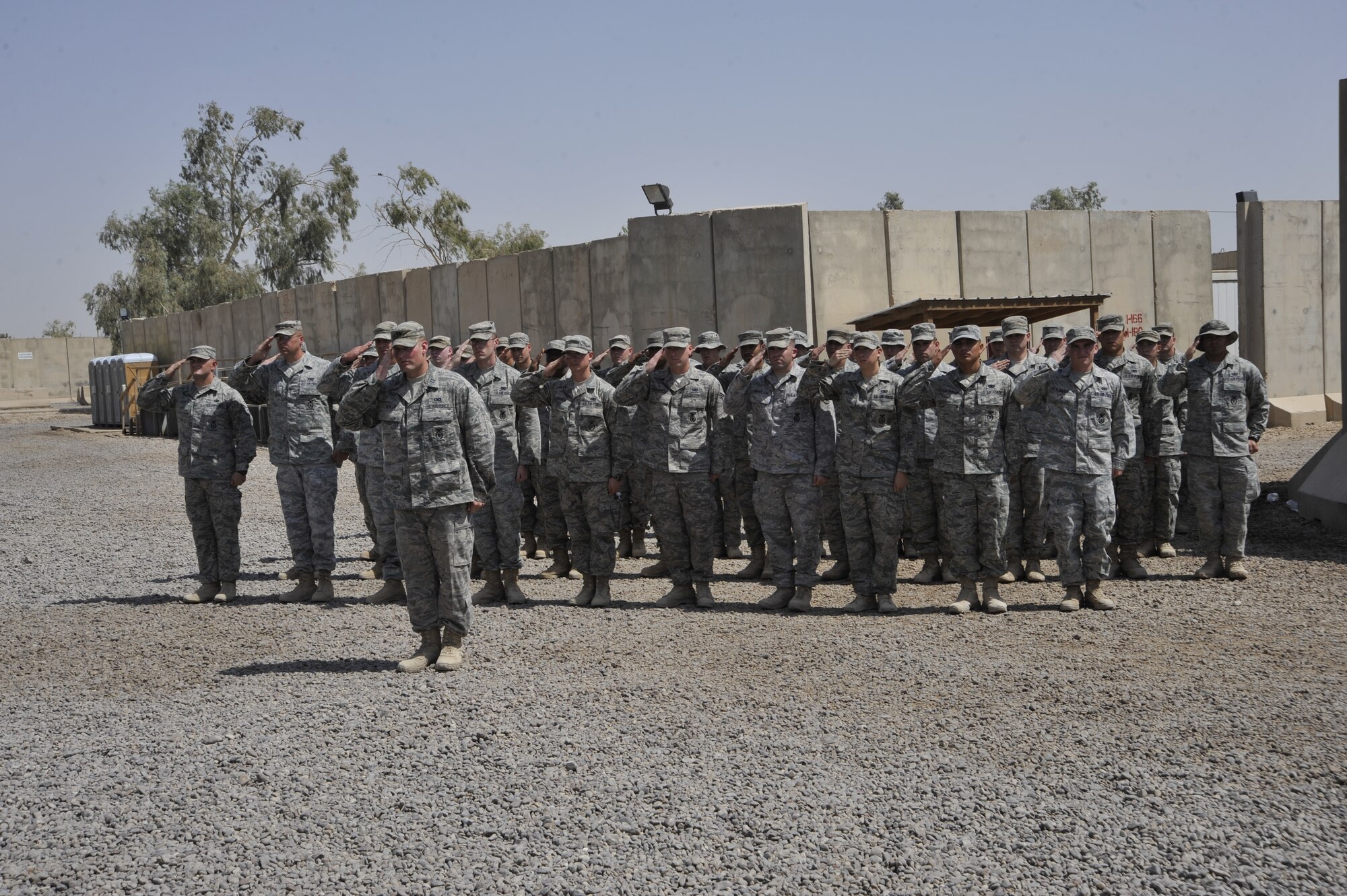 The 732nd Expeditionary Detachment 2, Airmen give a final salute to Maj. David Lederer, 732nd ESFS, Det. 2, commander during the deactivation of the 732nd ESFS, Det. 2 and the transfer of authority of the police transition team mission to the 94th Military Police Company, July 26, 2010, during at Camp Stryker, Iraq. The Soldiers will be taking over the PTT mission from the Det. 2 Airmen. ( U.S. Air Force photo by Perry Aston) (Released) 