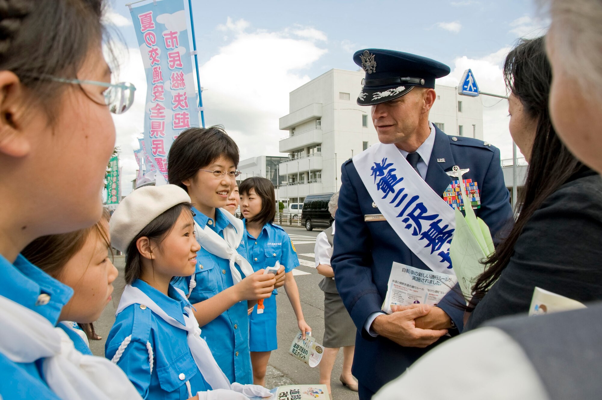 MISAWA CITY, Japan-- Col. RC Craig, 35th Fighter Wing commander, talks with the Misawa City Traffic Safety Awareness Group outside the Misawa City Civic Center, July 28. Colonel Craig and the traffic safety group handed out flyers to drivers promoting traffic safety throughout Misawa. 