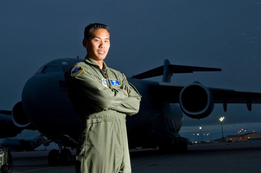 OFF BY A DIGIT - A C-17 Globemaster III pilot, Kim felt relief when a medical board said he could continue his aviation career after losing part of his left ring finger. Below, some of the other pilots in his squadron had a morale patch made for the major that depicts his injured hand. Kim proudly wears it on his uniform. (Photo by TSgt Samuel Bendet)