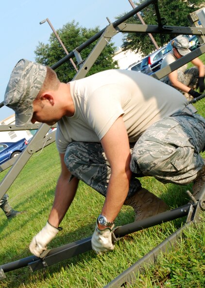 Staff Sgt. Cecil Guy, 919th Services Flight, places a purlin between two arches of a Temper tent at Duke Field July 10. The flight set up the tent as part of their annual field training. (U.S. Air Force photo/Tech. Sgt. Cheryl Foster) 
