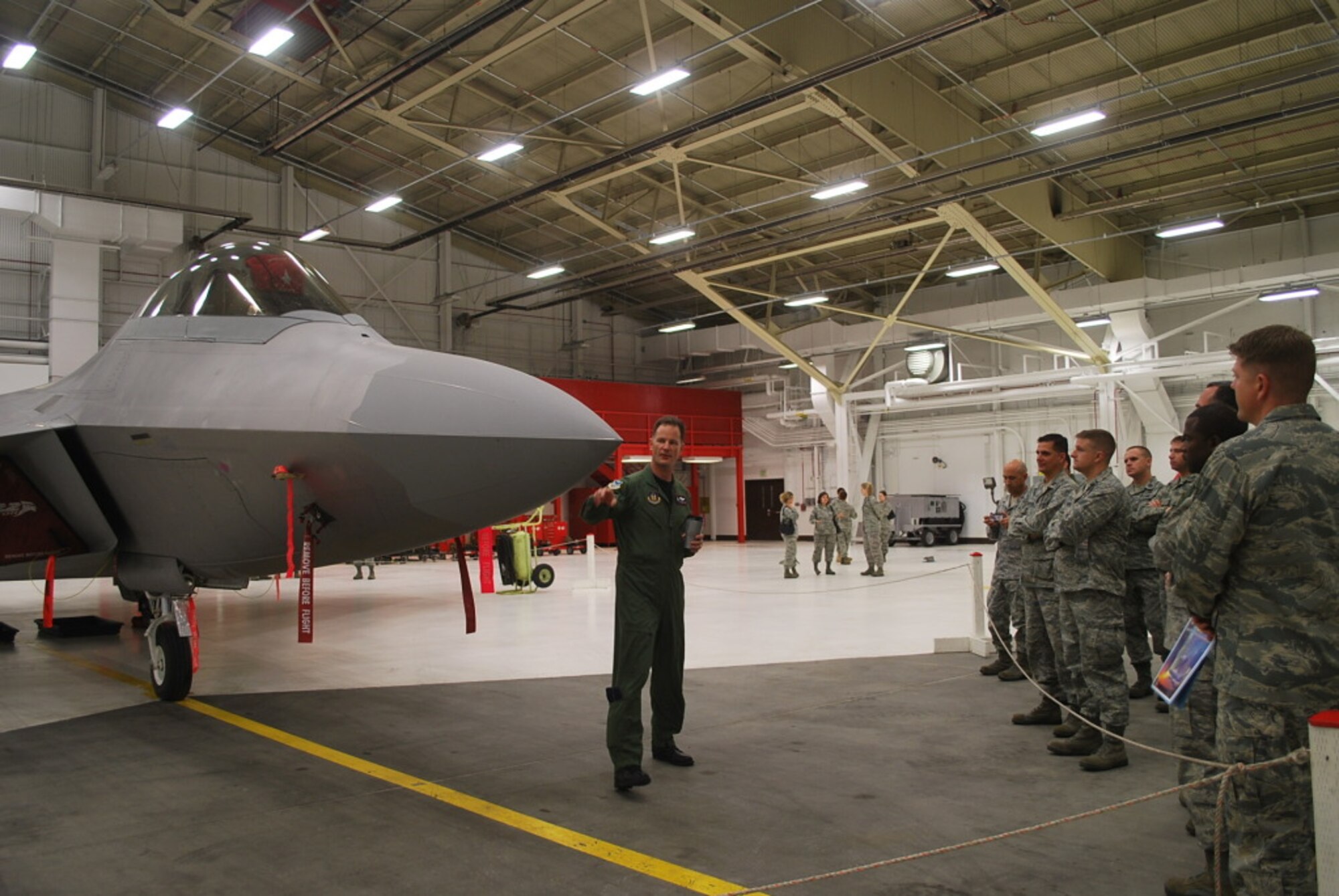 JOINT BASE ELEMENDORF RICHARDSON, Alaska -- Col. Eric Overturf, 477th Fighter Group commander, briefs Junior Officer Leadership Development Course attendees about the capabilities of the F-22 here July 10. The 477th Fighter Group hosted the JOLD Course here July 8-11. The course was attended by 28 active duty, Reserve and National Guard officers from bases throughout the Air Force.  The theme for the conference, which focused on joint operations, Alaska’s strategic location and supporting the Pacific theater was “Joint Force on Top of the World”. 