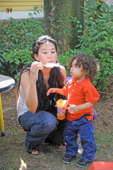 Julie and Genghis Webb blow bubbles in the backyard of the Ronald McDonald House July 20, 2010, in New Haven, Conn. The Webb family has been staying at the Ronald McDonald House following Genghis liver transplant surgery in April, when his father, Senior Airman Mario Webb, donated 20 percent of his liver to his son. Airman Webb is assigned to the 23rd Special Tactics Squadron at Hurlburt Field, Fla. (U.S. Air Force photo/Staff Sgt. Mareshah Haynes)