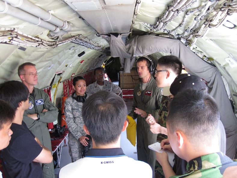 Korean media, AFN and 7th Air Force Airmen listen to Staff Sgt. Brian Porter (top right) Jul. 30, 2010, inside a KC-135 Stratotanker at Osan Air Base, South Korea. The 909th Air Refueling Squadron deployed to the peninsula in support of Invincible Spirit, July 26, 2010. Sergeant Porter is a boom operator from the 909th ARS. (U.S. Air Force photo/Mr. Won Hui Kim)