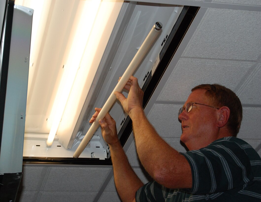 Mike McKito, facility manager, installs an energy-efficient light bulb in Bldg. 400 at Sheppard Air Force Base, Texas, July 30.  Facility Managers and facility occupants have a responsibility to collectively conserve Team Sheppard’s resources.  (U.S. Air Force photo/Tech. Sgt. Vernon Cunningham)