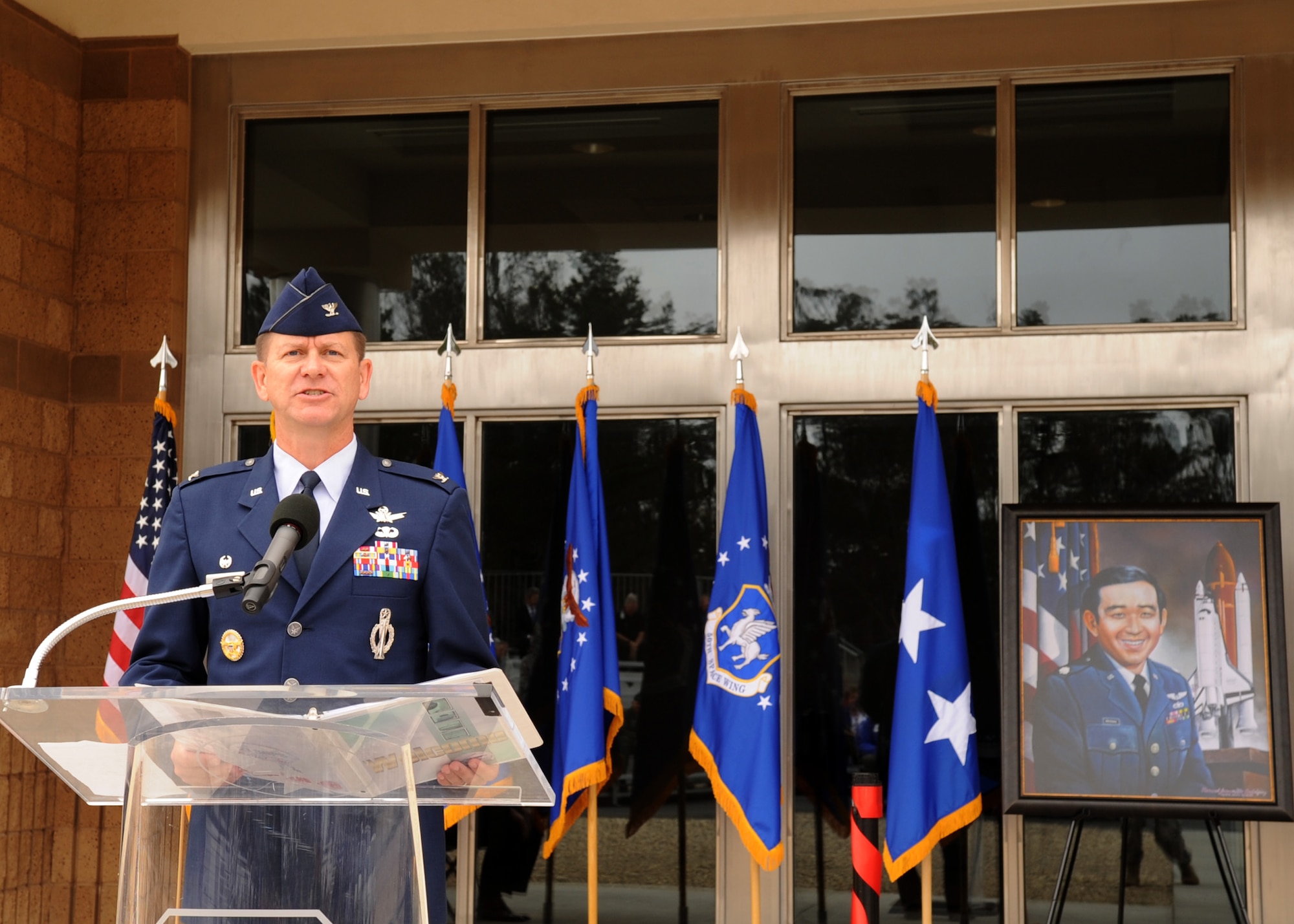 VANDENBERG AFB, Calif.-- Col. Wayne Monteith, the 50th Space Wing commander, delivers a speech during the dedication ceremony of the new Ellison Onizuka Satellite Operations Facility here Friday, July 30, 2010. Onizuka Air Force Station, previously located in Sunnyvale, officially closed July 28. The 21st Space Operations Squadron transferred here as part of an effort to consolidate satellite command and control operations while reducing excess infrastructure. Onizuka AFS was selected for closure by the Base Closure and Realignment Commission in 2005 (U.S. Air Force Photo/Senior Airman Bryan Boyette)