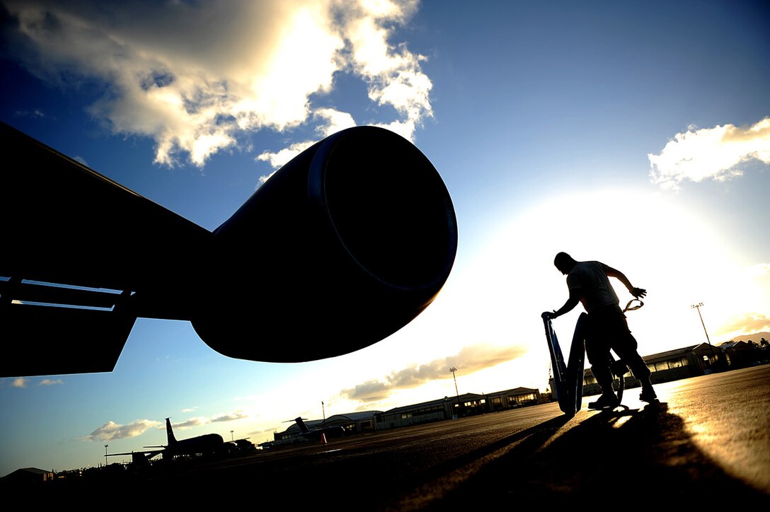 Senior Airman Jonathan Ordonez, a KC-135 crew chief with the 507th Aircraft Maintenance Squadron, Tinker Air Force Base, Okla., prepares to cover an engine after a refueling mission on July 8, 2010, in support of RIMPAC 2010 at Hickam AFB, Hawaii. In the future, Air Force Reserve Command plans to use its new Force Generation Center to identify and fill requirements with reservists. The new way of doing business is expected to give planners better insight on what resources are available and how they will be used. (U.S. Air Force photo/Master Sgt. Jeremy Lock)