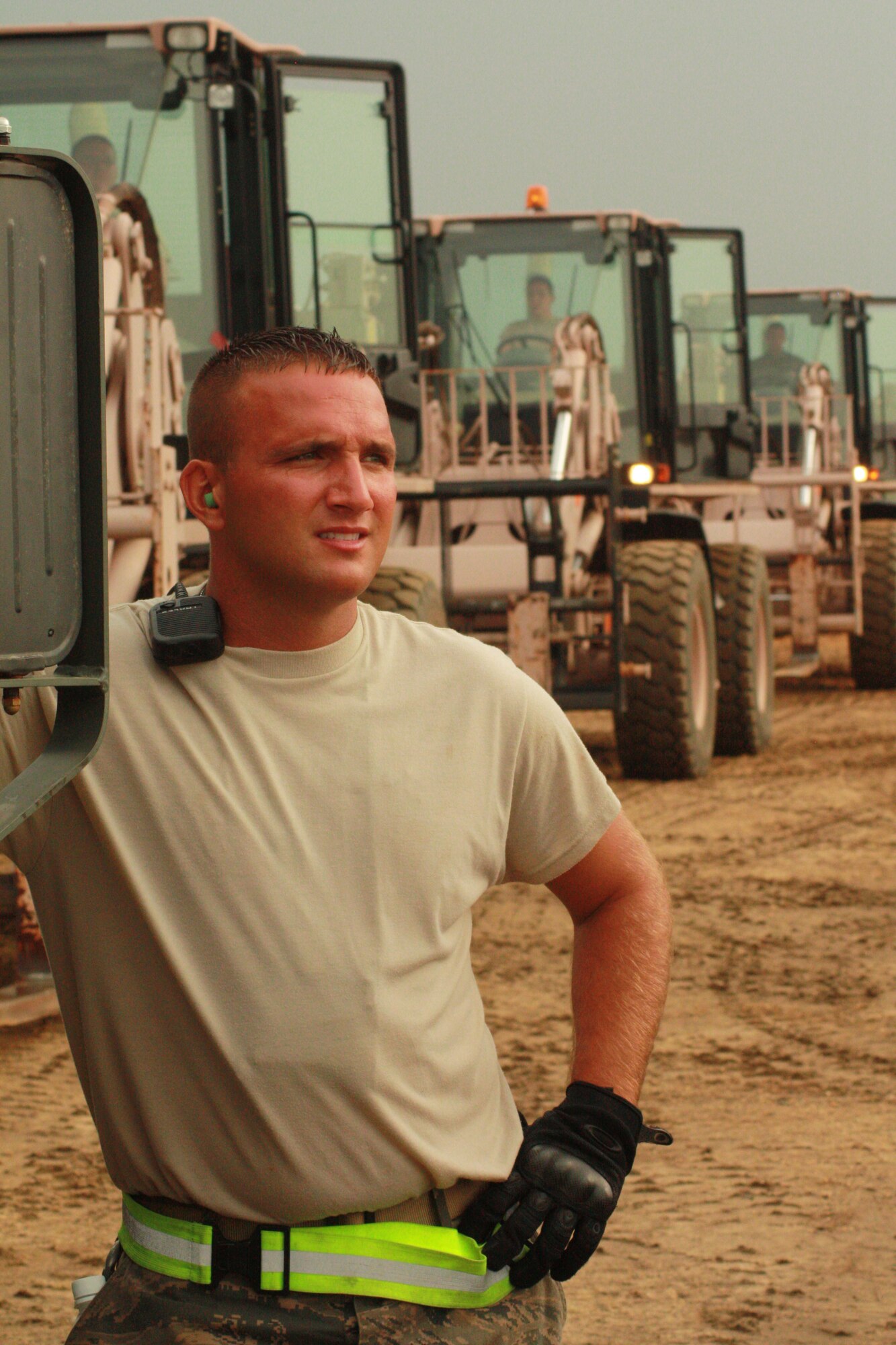 Staff Sgt. Brian Leach with the Joint Task Force-Port Opening 123rd Contingency Response Group waits with forklifts while an Air Force aircraft to lands and offloads pallets of food, water and shelter to be distributed to the local villages of Nessor as part of humanitarian relief efforts. (U.S. Army photo by Capt. Andi Hahn, Kentucky National Guard Public Affairs Office)

 (U.S. Army photo/Capt. Andi Hahn)(Released)