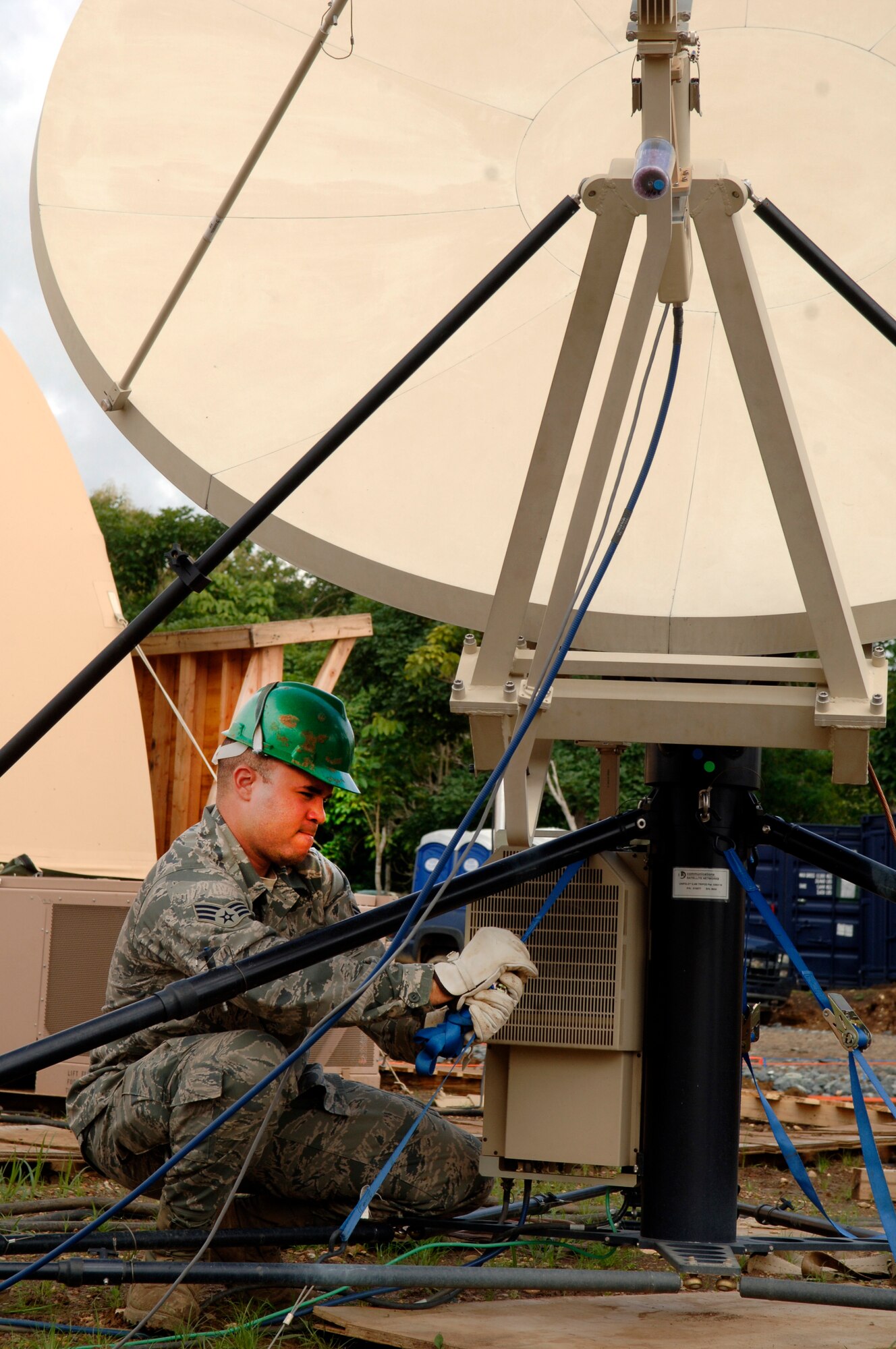 Senior Airman Cesar Morales, deployed from the 32nd Combat Communications Squadron, secures the base of the satellite array during New Horizons Panama 2010. (U.S. Air Force photo/Tech. Sgt. Eric Petosky)
