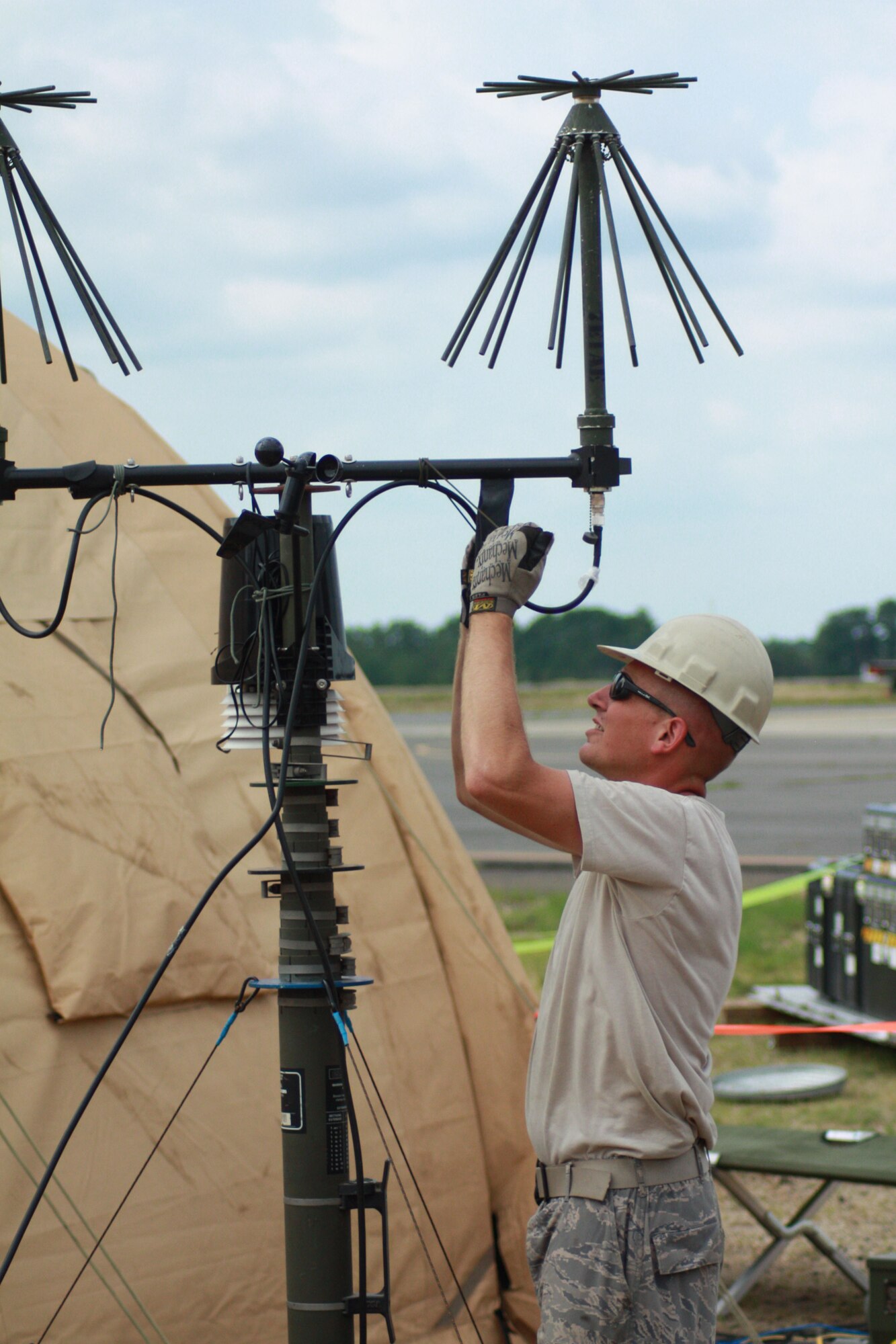 TSgt Philip Seif from the Kentucky Air National Guard's 123rd Contingency Response Group based out of Louisville, Ky.,  assembles a communications antenna at Lakehurst Air Field at McGuire Air Force Base after arriving to provide humanitarian assistance as part of a joint exercise on July 28.
 (U.S. Air Force photo/MSgt Phil Speck)(Released)