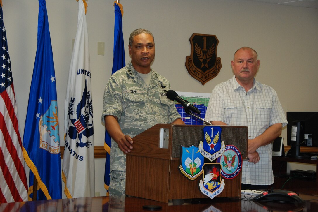 Maj. Gen. Garry C. Dean, Air Forces Northern commander (left) briefs members of the media during a press conference with retired Adm. Thad Allen (right), National Incident Commander for the Deepwater Horizon oil spill response operation during the admiral’s visit to the Aviation Coordination Command at Tyndall Air Force Base, Fla., July 30, 2010.