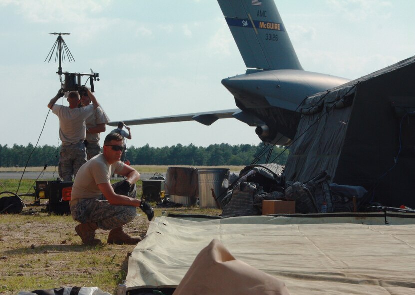 Chaplain (Lt. Col.) James Ehrman of the Kentucky Air National Guard's 123rd Contingency Response Group takes a quick break while assembling a tent after arriving July 27 at Joint Base McGuire-Dix-Lakehurst, N.J. to participate in joint exercise Eagle Flag, simulating humanitarian relief efforts in the fictional nation of "Nessor."  (U.S. Army photo by Capt. Andi Hahn/Released)