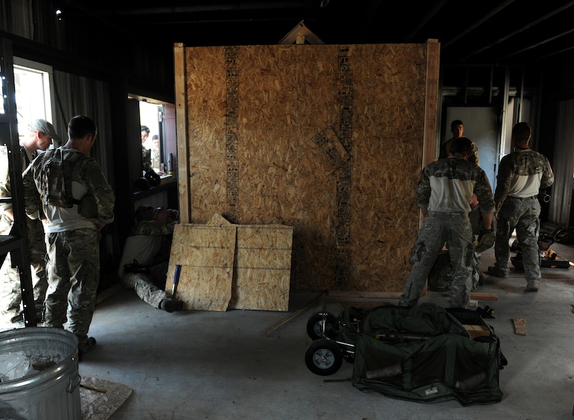 MOODY AIR FORCE BASE, Ga. -- Personnel of the 38th Rescue Squadron personnel along with rescue equipment instructors built a structure to simulate a collapsed building for confined spaces training here July 29. The structure contained furniture, construction supplies and barrels to simulate real-world search and rescue conditions. (U.S. Air Force photo by Airman 1st Class Benjamin Wiseman/RELEASED)
