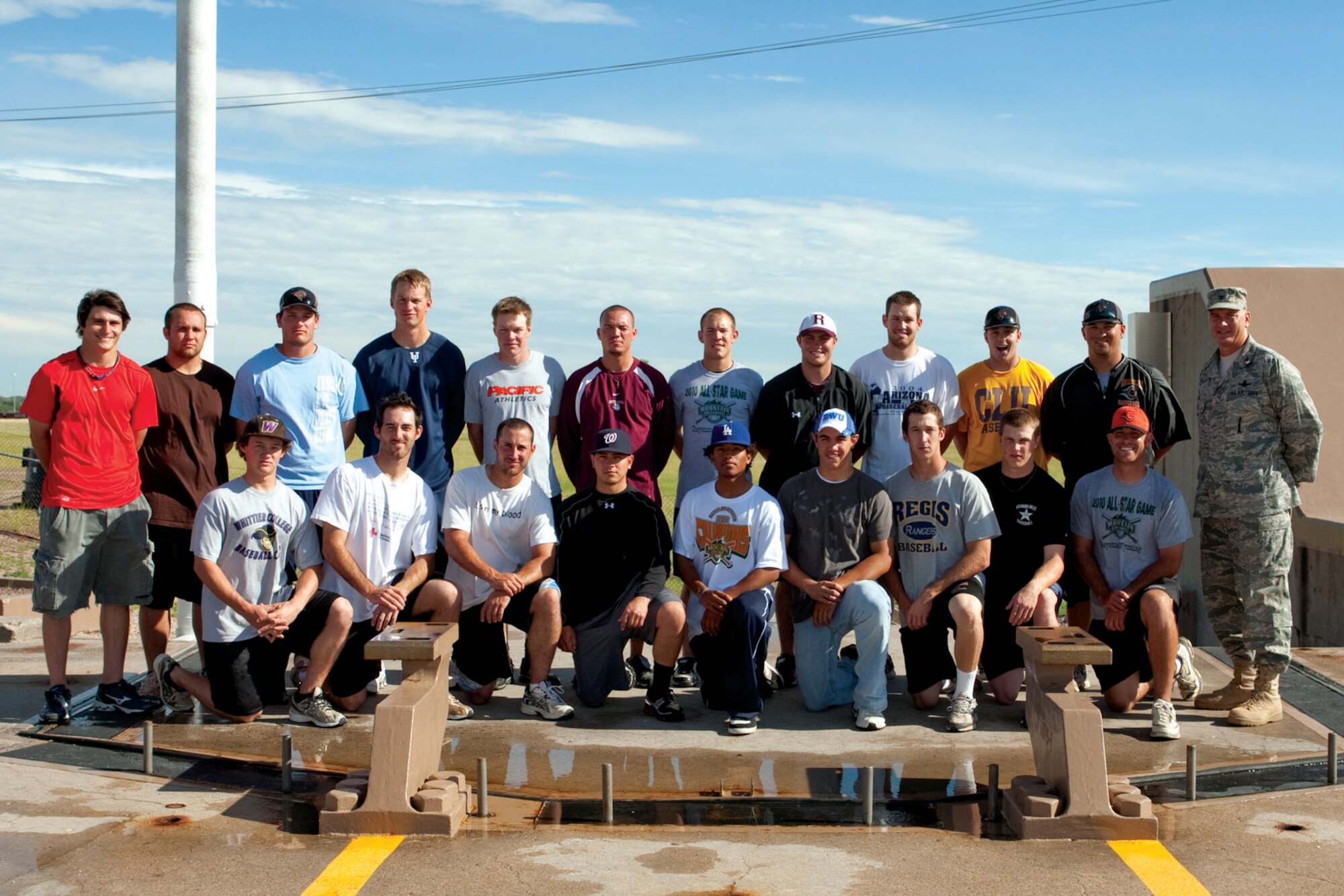 The Cheyenne Grizzlies pose with Col. Greg Tims, 90th Missile Wing commander, for a photo at the Uniform-01 training site July 21 as part of a base tour. (U.S. Air Force photo by Jeff Allred)