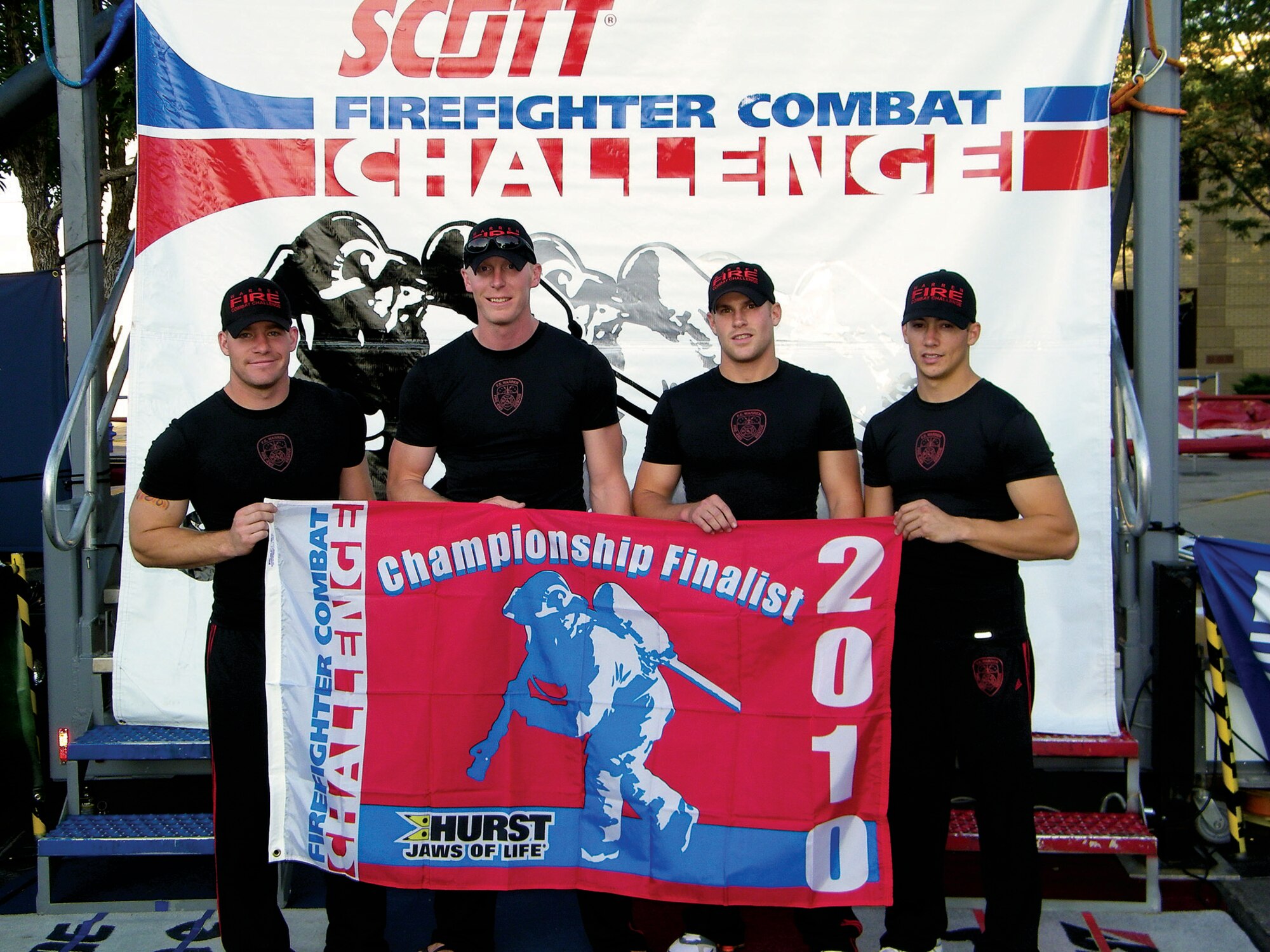 Senior Airman Andrew Kose, Joshua Sarters,  Airman 1st Class Kory Lindbom and Senior Airman Steven Tingey, 90th Civil Engineer fire department, pose for a team photo after competing in the Scott Firefighter Combat Challenge on July 17 and 18 in Rapid City, S.D. This was the team’s first entrance into the event, and they were said to have stood out quickly as a team that was well prepared and ready to compete against many of the experienced teams there. They will be competing in Casper, Wyo., Saturday and Sunday. (U.S. Air Force photo by Tech Sgt. Mike Falzone)