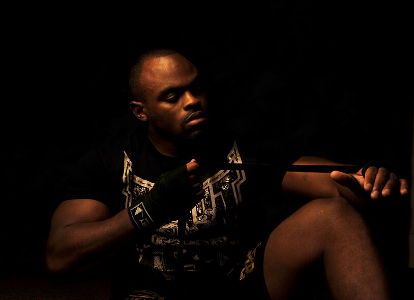 MOODY AIR FORCE BASE, Ga. -- Staff Sgt. Clint Williams, 23rd Maintenance Operations Squadron production manager, wraps his hands as if preparing for a fight here July 29. Sergeant Williams trains and fights in mixed martial arts in his off-duty time and in his first fight of his professional amateur career gained a Georgia record for quickest knockout. (U.S. Air Force photo by Airman 1st Class Joshua Green/RELEASED)