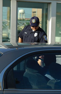 Officer Davidson checks identification of a driver entering through the Hruskocy Gate during the morning influx of employees. To many Tinker workers and visitors, the officers that safeguard the gates are the only law enforcement they see so the name “gate guard” is frequently used. But the Department of Defense police provide base and personnel protection in many more roles. (Air Force photos by Margo Wright)