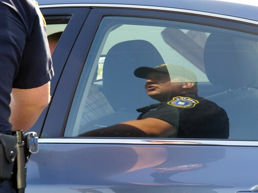 During a patrol of the base, Officer Tipton stops a speeding driver.  He prefers to educate drivers, not write tickets, taking everything about each situation into account. “I’m not out to get anybody, ruin someone’s day.  Just out to enforce the law,” he said.  Depending on the violation, some tickets can earn a careless driver more than just points against their base driving privileges; certain violations will show on their driving record and affect their insurance. (Air Force photos by Margo Wright)