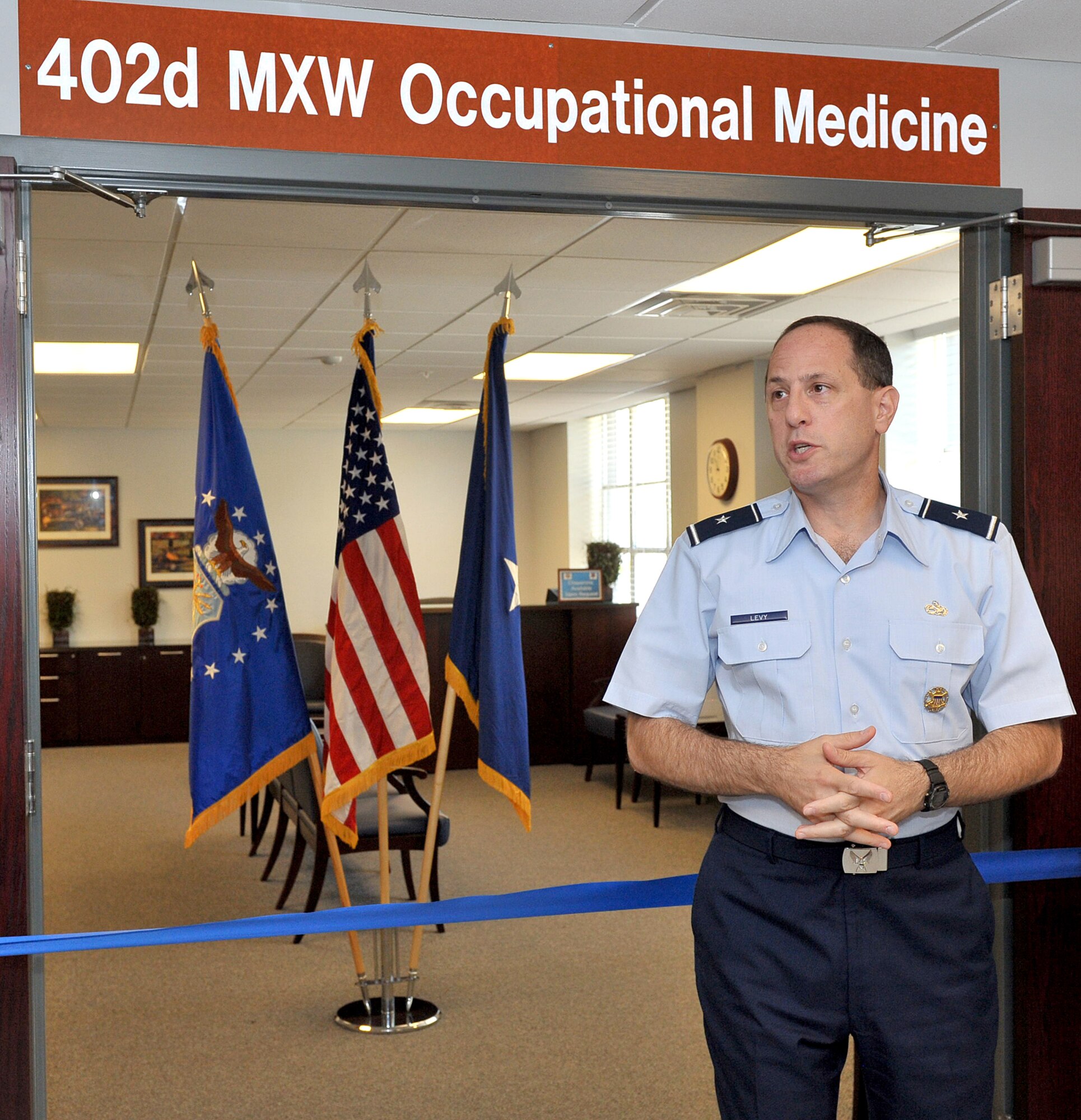 Brig. Gen. Lee Levy, 402nd Maintenance Wing commander, presides over a ribbon cutting ceremony Monday for the new occupational medicine facility. in Bldg. 155.  U.S. Air Force photo by Tommie Horton