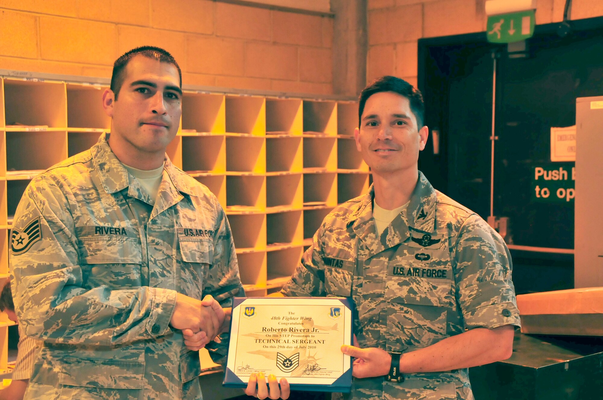 Tech Sgt. Roberto Rivera, 48th Communications Squadron postal supervisor is promoted by 48th Fighter Wing Commander Col. John Quintas July 27. Sergeant Rivera was promoted from staff to technical sergeant under the Stripes for Exceptional Performers (STEP) program, which instantaneously promotes individuals outside of the normal promotion cycle. (U.S. Air Force photo/Airman 1st Class Eboni Knox)