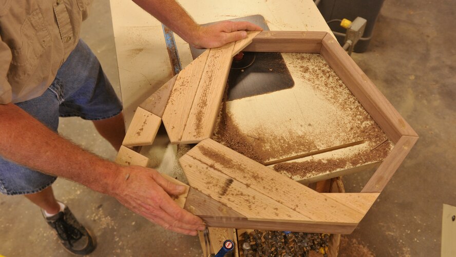 MOODY AIR FORCE BASE, Ga. -- Jim Connelly, Wood Shop supervisor, uses a disc sander to cut the inside of a shadow box here July 9. The sander was used to cut out slots for the back of the shadow box where the back cover will be placed. (U.S. Air Force photo by Airman 1st Class Joshua Green/RELEASED)
