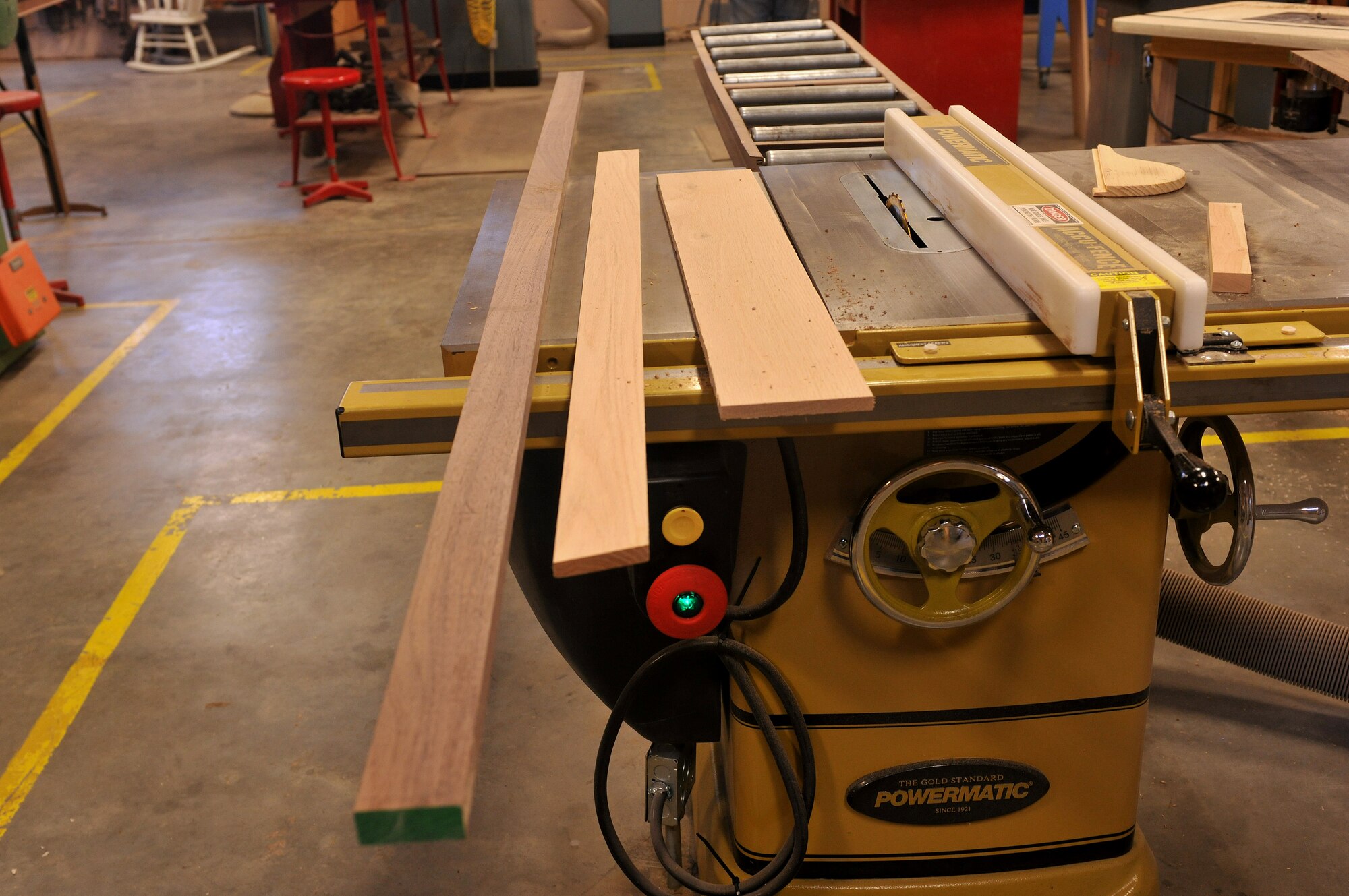 MOODY AIR FORCE BASE, Ga. -- Three pieces of wood lay on a saw table before being cut for use as part of a shadow box here July 9. The types of wood used to create the shadow box are black walnut and red oak, which provide a unique look when finished. (U.S. Air Force photo by Airman 1st Class Joshua Green/RELEASED) 