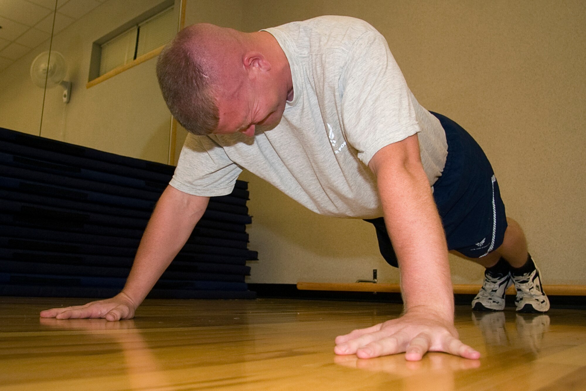 GRISSOM AIR RESERVE BASE, Ind. -- Staff Sgt. Joshua Carter strains to get those last couple pushups in before his minute is up during the pushup component of a fitness test he took here recently. Starting in July, the Air Force implemented new fitness assessment standards, which now include bi-annual testing, minimum requirements within testing components and establishing fitness assessment cells to proctor tests. Pushups count for ten of the possible 100 points. Sergeant Carter is a structural repair specialist with the 434th Maintenance Squadron. (U.S. Air Force photo/Tech. Sgt. Mark R. W. Orders-Woempner)