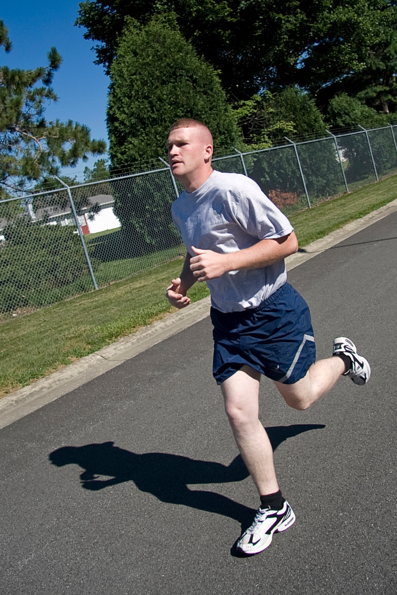 GRISSOM AIR RESERVE BASE, Ind. -- Staff Sgt. Joshua Carter races by during a fit-to-fight fitness test here recently. Starting in July, the Air Force implemented new fitness assessment standards, which now include bi-annual testing, minimum requirements within testing components and establishing fitness assessment cells to proctor tests. Airmen must meet minimum requirements as defined by the new instruction for each of the four components. Components are weighted as follows: 60 points for aerobic, 20 points for body composition, 10 points for pushups, and 10 points for sit-ups, for a total of 100 possible points. Sergeant Carter is a structural repair specialist with the 434th Maintenance Squadron. (U.S. Air Force photo/Tech. Sgt. Mark R. W. Orders-Woempner)