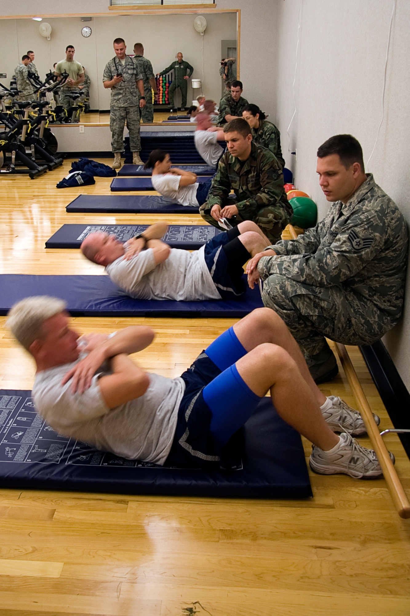 GRISSOM AIR RESERVE BASE, Ind. -- Members of the 434th Air Refueling Wing take part in the sit-up portion of a fitness test held here recently. Starting in July, the Air Force implemented new fitness assessment standards, which now include bi-annual testing, minimum requirements within testing components and establishing fitness assessment cells to proctor tests. Sit-ups count for ten of the possible 100 points. (U.S. Air Force photo/Tech. Sgt. Mark R. W. Orders-Woempner)