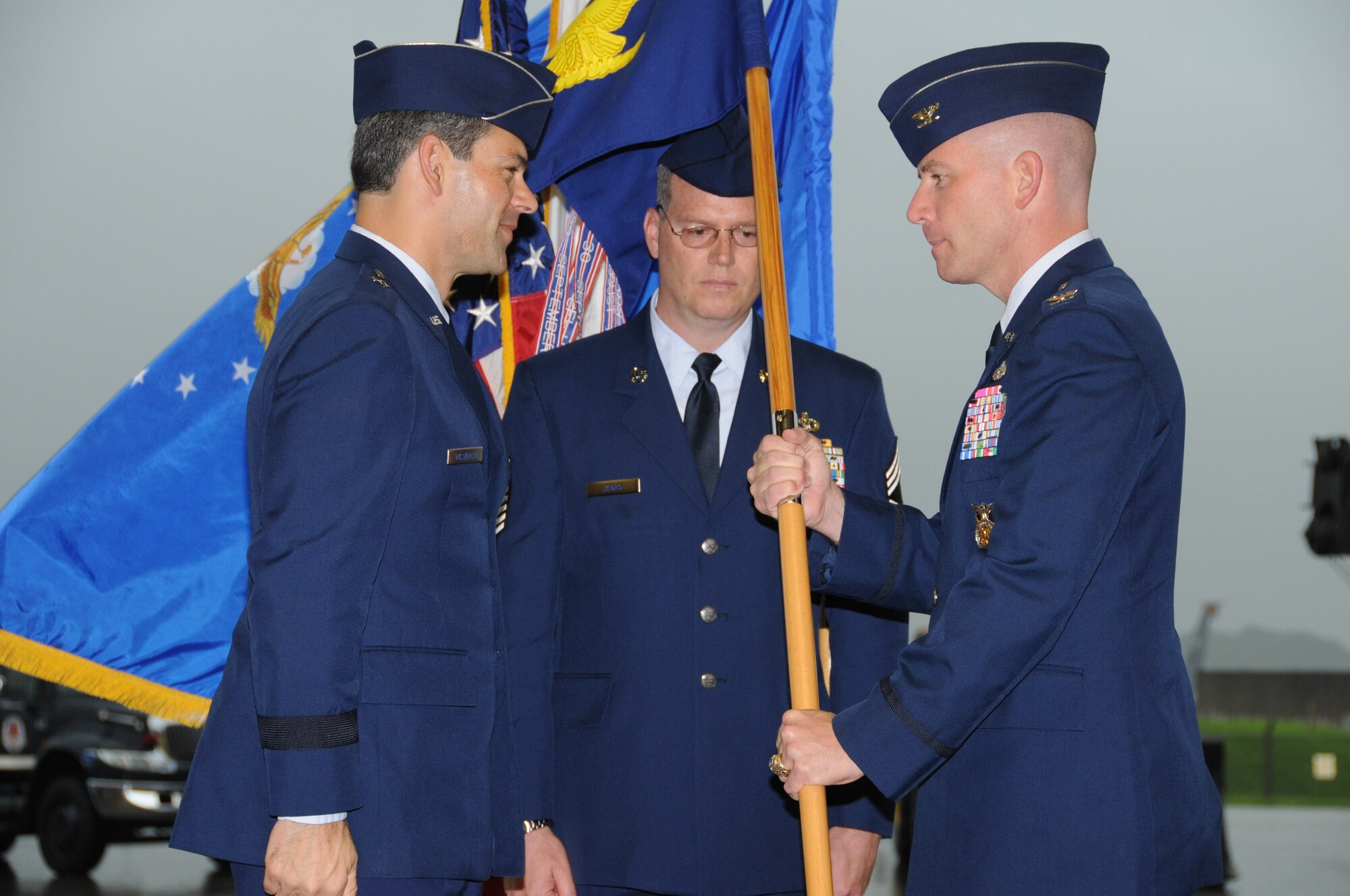 Col. Brian Duffy, 18th Civil Engineer Group commander, accepts the group guidon from Brig. Gen. Ken Wilsbach, 18th Wing commander, during a change of command ceremony at the AWACS hangar here July 29. (U.S. Air Force photo/Staff Sgt. Darnell Cannady)