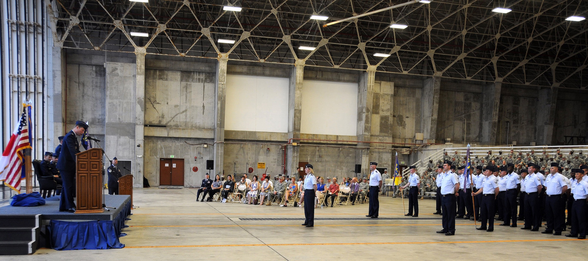 Col. Scott Jarvis, outgoing 18th Civil Engineer Group commander, addresses his Airmen one last time before handing over the guidon to Col. Brian Duffy during a change of command ceremony at the AWACS hangar here July 29. (U.S. Air Force photo/Staff Sgt. Darnell Cannady)