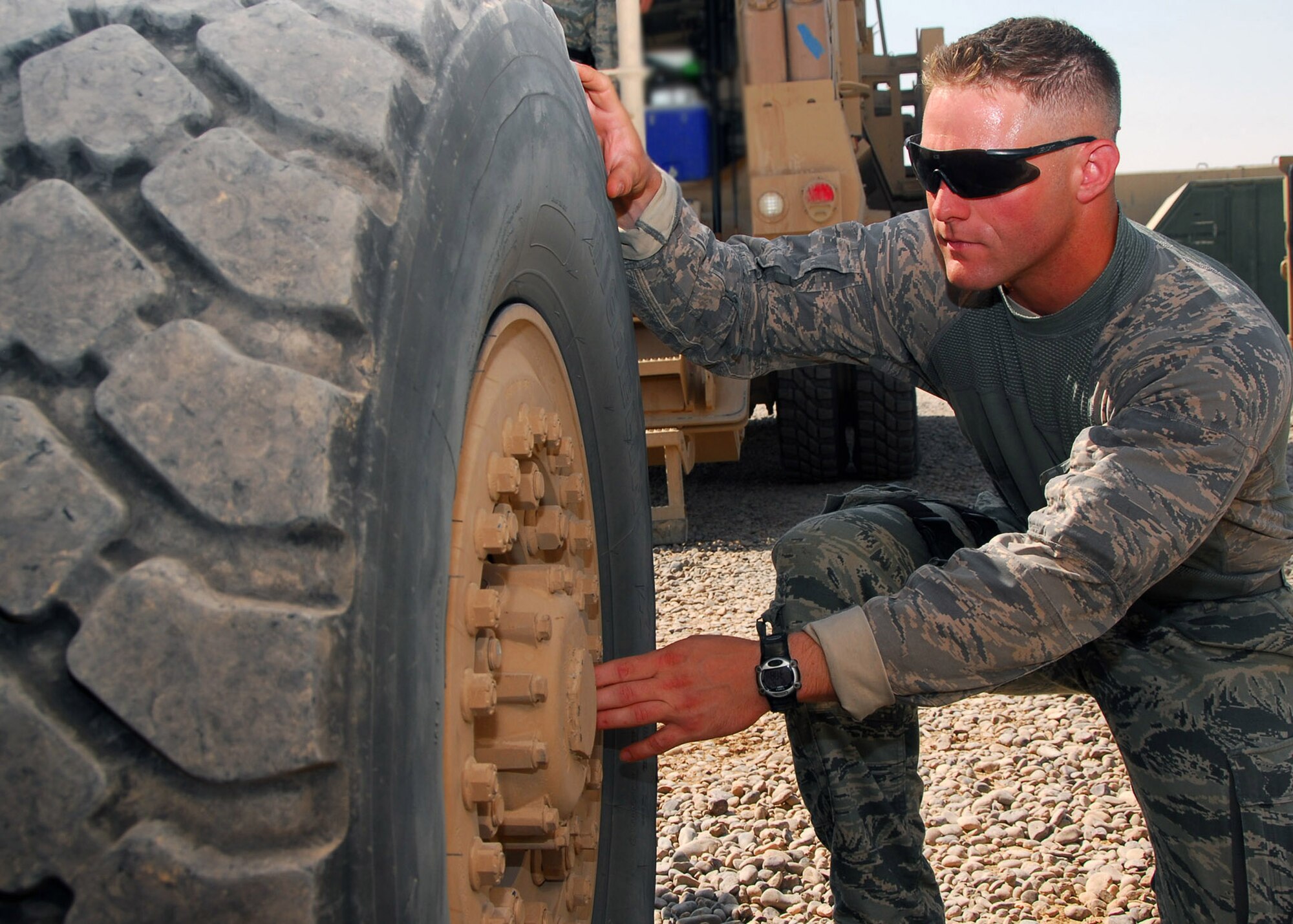 Senior Airman Ryne Ritchie, 532nd Expeditionary Security Forces Squadron truck commander, inspects the lug nuts on an MRAP July 25, 2010, at Joint Base Balad, Iraq. Preparation inspections are done before each patrol to ensure equipment, vehicles, and weapons are working properly. Airman Ritchie is deployed from Travis Air Force Base, Calif., he is a native of Chino, Calif. (U.S. Air Force photo/Senior Airman Marianne E. Lane)