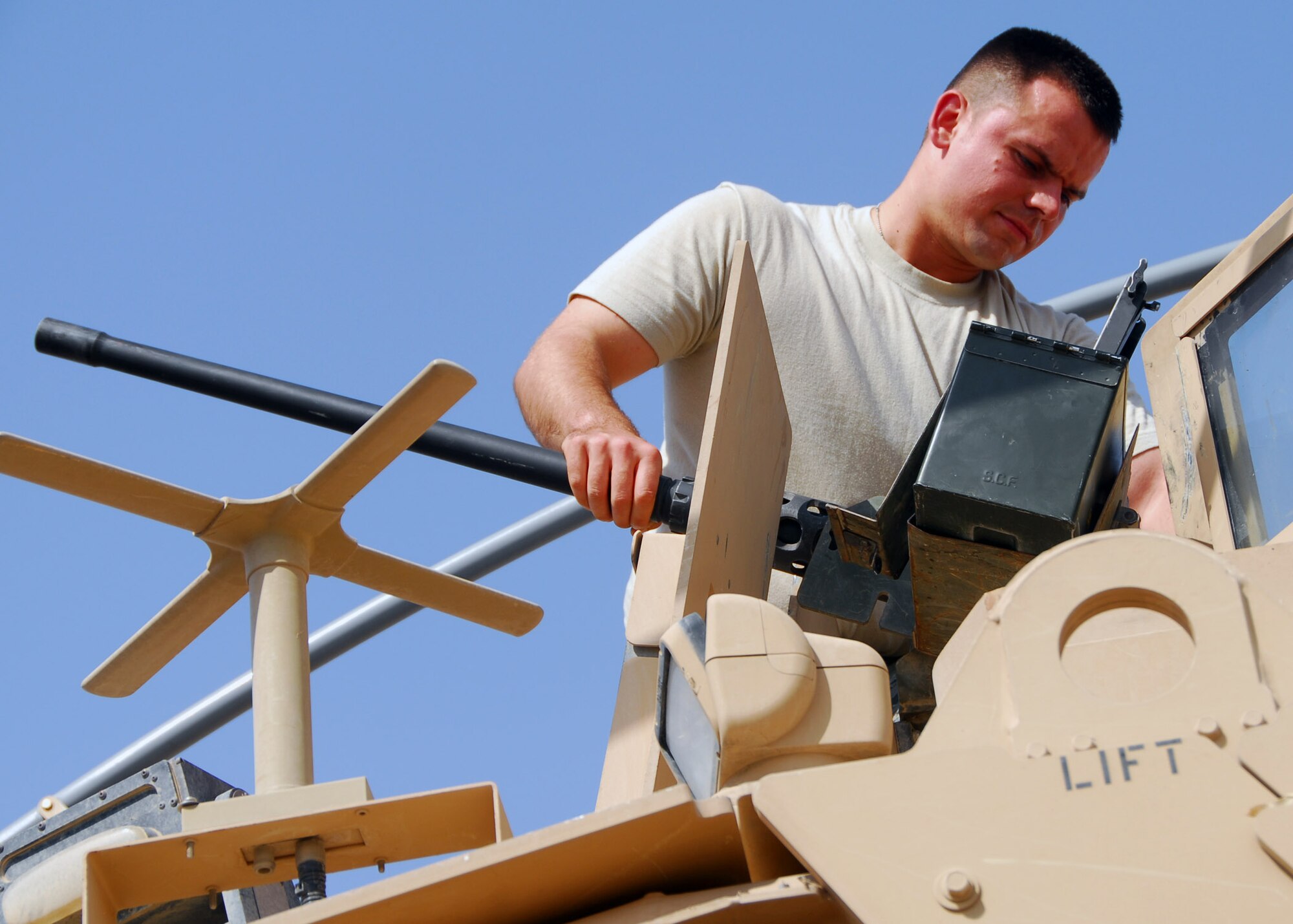 Staff Sgt. Pavel Kovalchuk, 532nd Expeditionary Security Forces Squadron M-2 gunner, inspects the M-2 50-caliber weapons system July 25, 2010, Joint Base Balad, Iraq.  This system is inspected by the squad every time before going out on patrol to ensure it functions properly and accurately. Sergeant Kovalchuk is deployed from Andrews Air Force Base, Md., he is a native of Lithuania, Russia (U.S. Air Force photo/Senior Airman Marianne E. Lane)