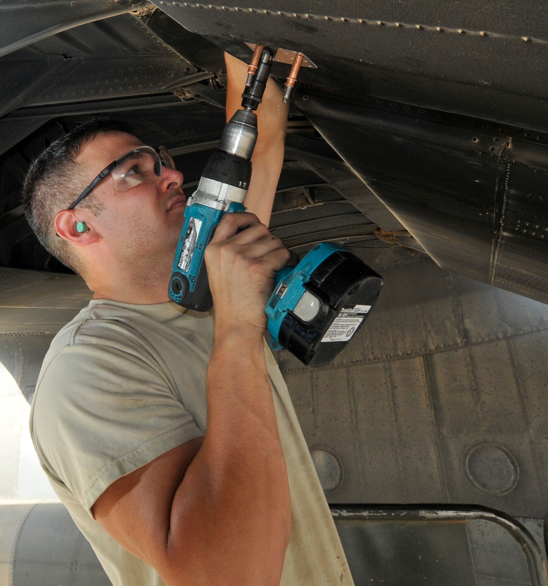Staff Sgt. Francisco Velasquez, 332nd Expeditionary Maintenance Squadron aircraft structural maintenance craftsman, drills recesses in an aluminum patch allowing rivets to sit flush July 24, 2010, Joint Base Bald, Iraq. The placement of the crack and thickness of metal determine whether the repair will be with a patch or sealant. Sergeant Velasquez is a native of Monroe, Mich., deployed from Little Rock Air Force Base, Ark. (U.S. Air Force photo/Staff Sgt. Phillip Butterfield)