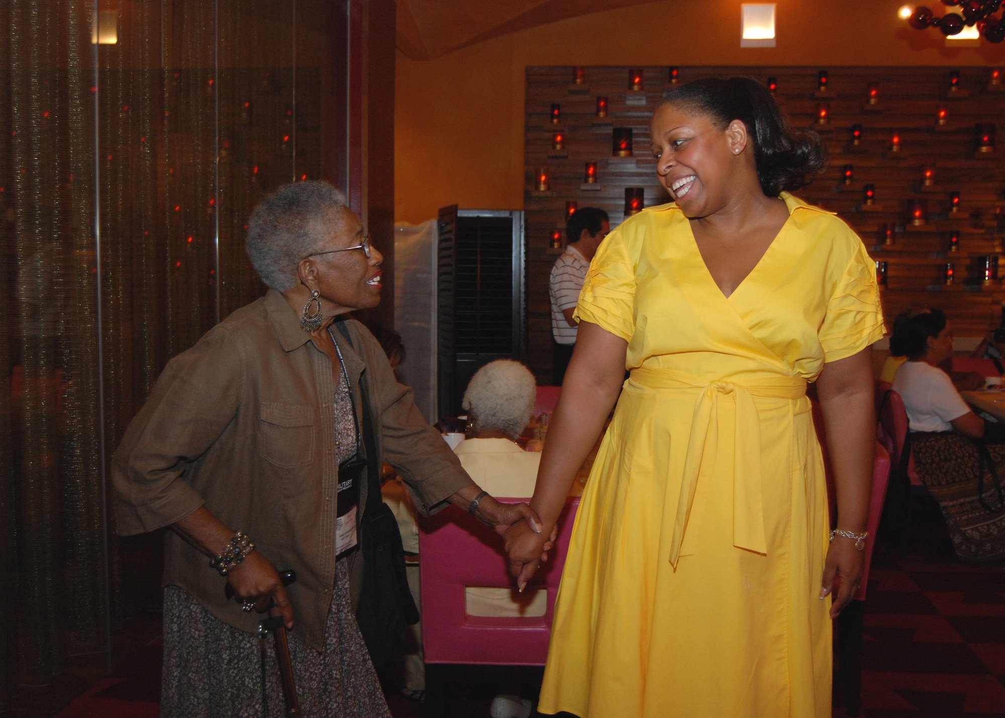 Jennifer Myers (right), national historian of the Tuskegee Airmen Incorporated, welcomes Dr. Nancy Leftenant-Colon, former president of the TAI,  during the Spouse's Tea in San Antonio, Texas, Jul 30.  The Spouse's Tea was one of many events held in conjunction with the 39th annual TAI national convention. (U.S. Air Force photo/Tech Sgt. Steve Lewis)