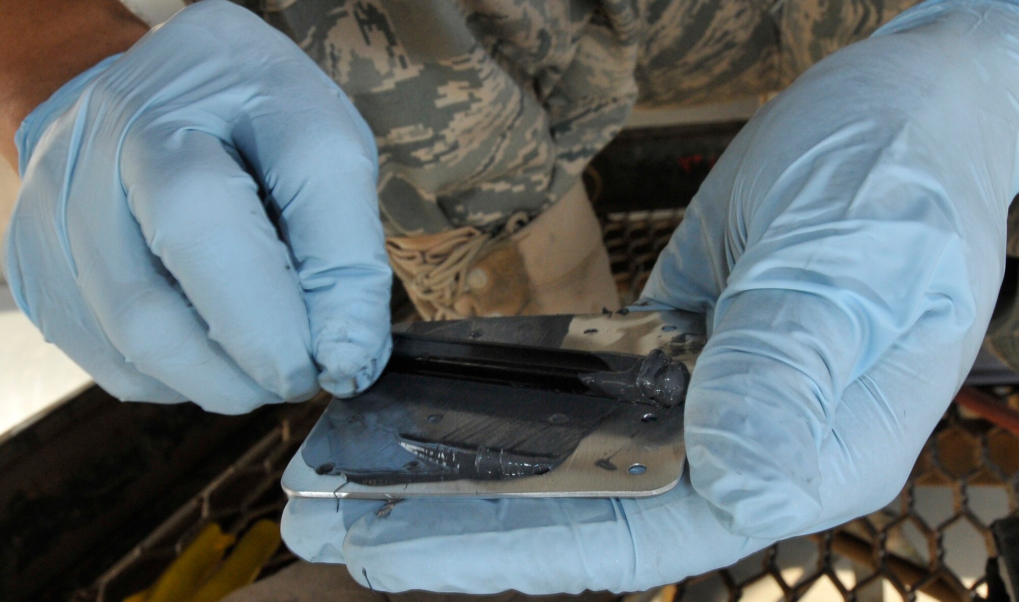 Staff Sgt. Francisco Velasquez, 332nd Expeditionary Maintenance Squadron aircraft structural maintenance craftsman, applies a waterproof sealant to an aluminum patch to cover a cracked C-130 Hercules wing baffle July 24, 2010, Joint Base Bald, Iraq. Maintenance Airmen use sealant to keep water and dirt from getting between the patch and the aircraft. Sergeant Velasquez is a native of Monroe, Mich., deployed from Little Rock Air Force Base, Ark. (U.S. Air Force photo/Staff Sgt. Phillip Butterfield)