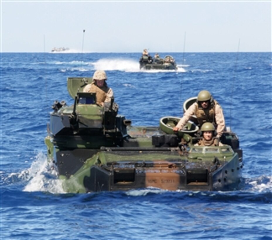 Soldiers assigned to Bravo Company, 2nd Battalion, Royal Australian Regiment approach the Royal Australian Navy amphibious transport ship HMAS Kanimbla (L 51) aboard U.S. Marine Corps amphibious assault vehicles in the Pacific Ocean during Rim of the Pacific 2010 on July 15, 2010.  