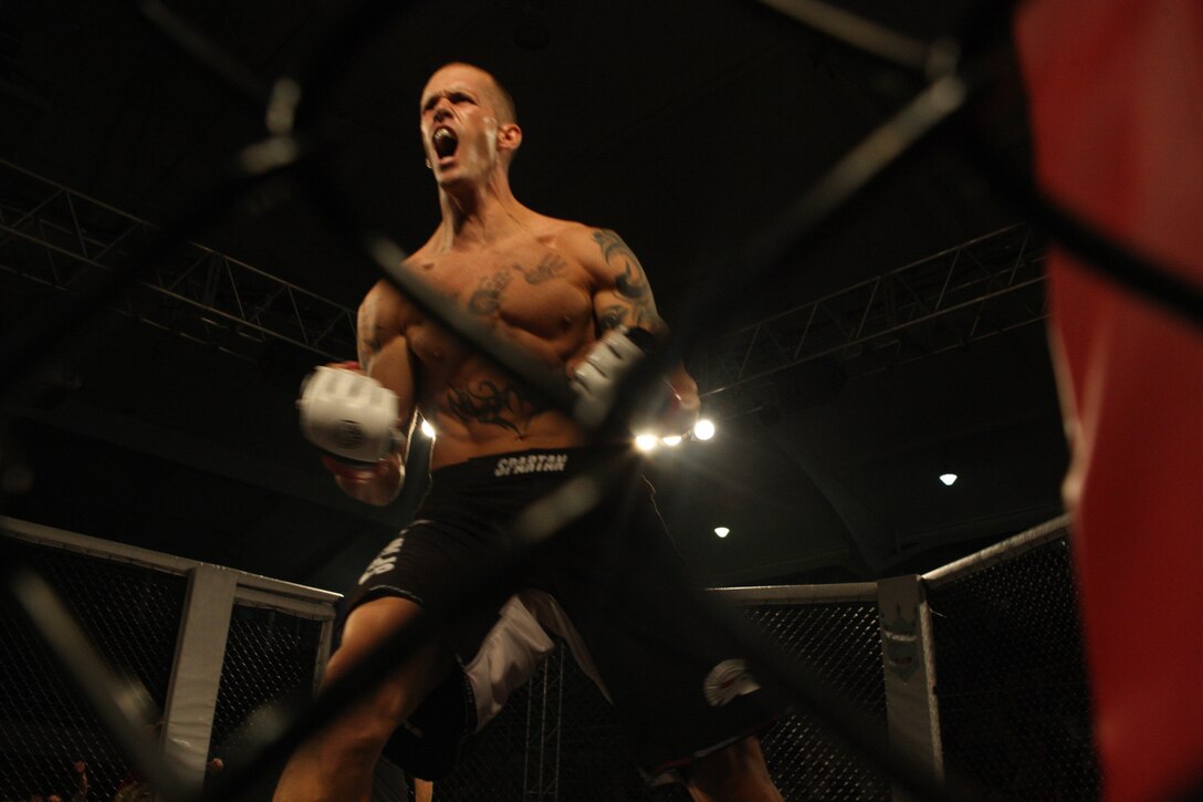 Jeff Hunt, of Team Corps, reacts to his quick win over Billy Craig, of Team Death Grip Mixed Martial Arts, during the Sacred Ground Mixed Martial Arts event at Goettge Memorial Field House aboard Marine Corps Base Camp Lejeune, July 31.