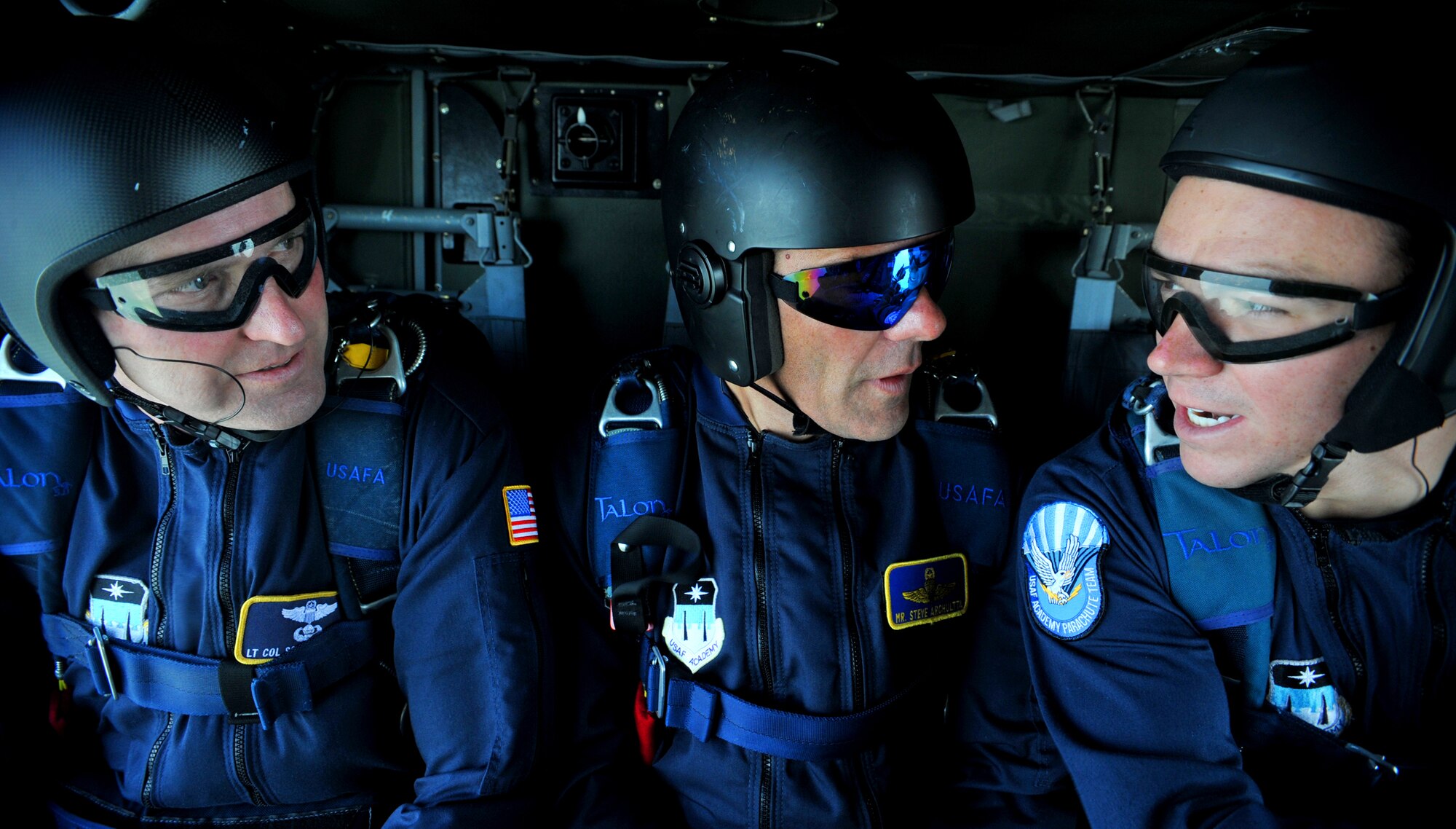 Lt. Col. Scott Drinkard, Steve Archuletta and Cadet 1st Class Jesse Galt, all members of the Wings of Blue Air Force Parachute Demonstration Team, talk about the jump they will perform while in the back of a UH-60 Black Hawk helicopter approaching 9,000 feet above Fort A.P. Hill, Va., July 25, 2010. The Wings of Blue is based at the U.S. Air Force Academy in Colorado Springs, Colo. (U.S. Air Force Photo/Senior Airman Andrew Lee)