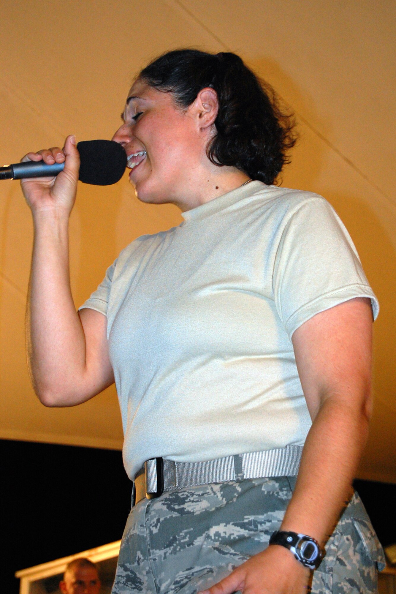 U.S. Air Force Staff Sgt. Jodi Langellotti, U.S. Air Forces Central Band New Directions, sings during a performance for the 379th Airlift Wing at a base in Southwest Asia July 26, 2010. Sergeant Langelltoti is deployed from the Air National Guard Band of the Northeast at Milford, Mass. The band’s mission is to create musical events designed to uplift morale and build positive internal and external relationships. New Horizons is scheduled to perform nearly 25 times until the middle of August throughout the U.S. Central Command area of responsibility. (U.S. Air Force photo by Maj. Chad Steffey/Released)