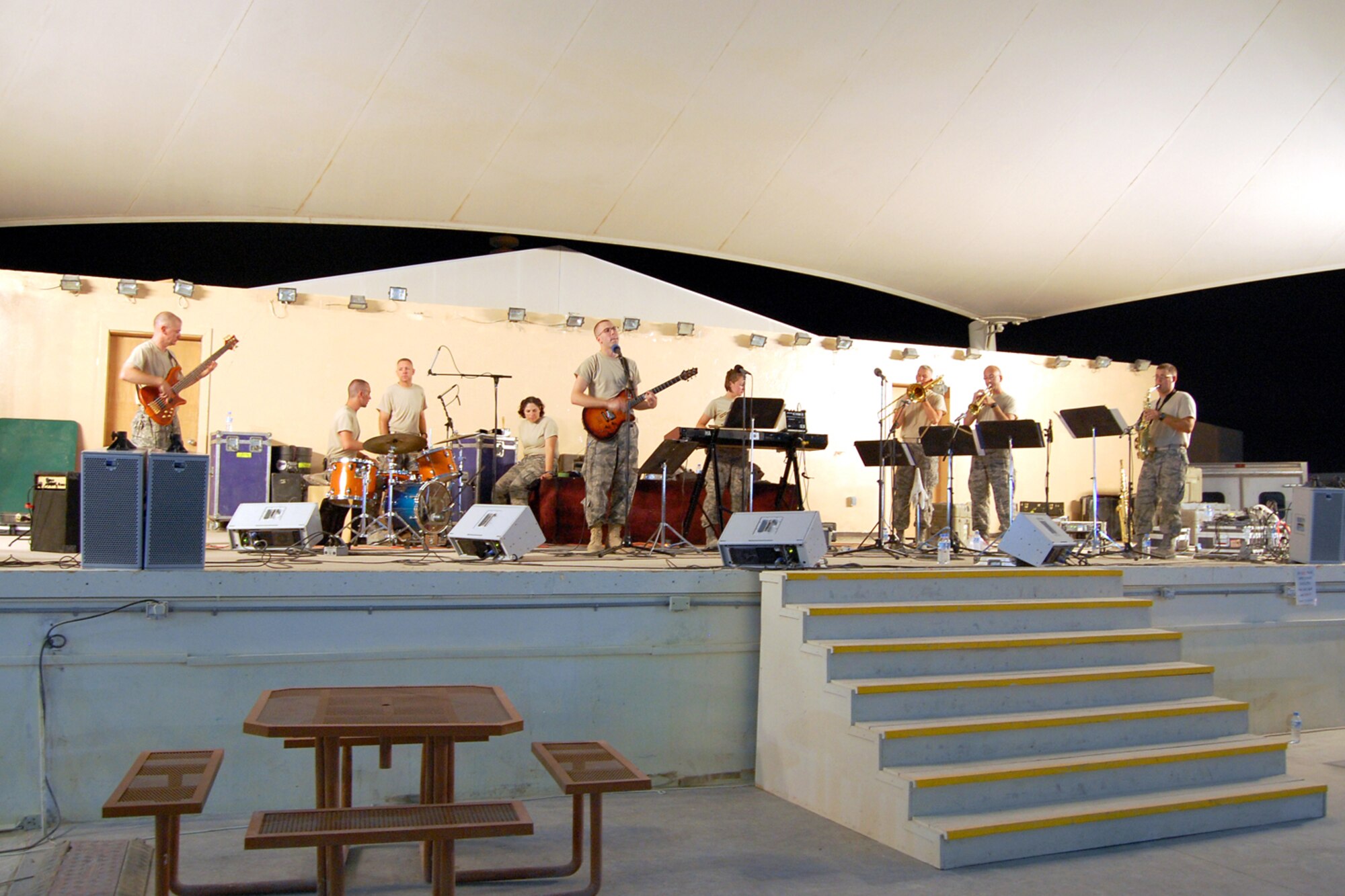 New Directions, the U.S. Air Forces Central Band, rock the stage for the 379th Airlift Wing at a base in Southwest Asia July 26, 2010. The band is deployed from the Air National Guard Band of the Northeast at Milford, Mass. The band’s mission is to create musical events designed to uplift morale and build positive internal and external relationships. New Horizons is scheduled to perform nearly 25 times until the middle of August throughout the U.S. Central Command area of responsibility. (U.S. Air Force photo by Maj. Chad Steffey/Released)